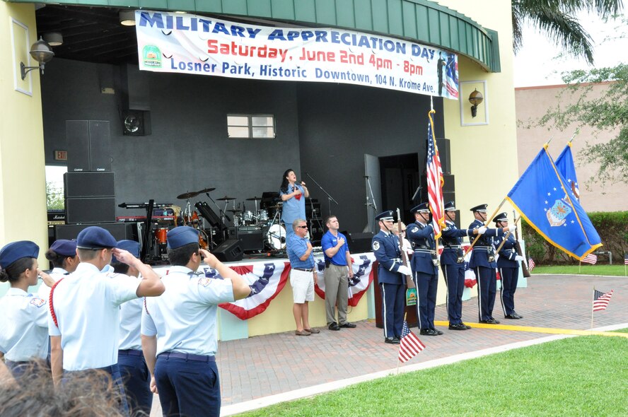 Loretta Marsicano sings the National Anthem as the Homestead Air Reserve Base Honor Guard presents the colors and the Homestead Senior High School Color Guard salutes to kick off the city of Homestead’s first annual Military Appreciation Day at Losner Park, June 2. The day featured an F-16 flyover from pilots of HARB’s 93rd Fighter Squadron, live-music performances from bands Main Highway and No Restrictions, a variety of food trucks, children’s activities, and a proclamation from Homestead Mayor Steven Bateman and city council was presented to Col. Donald Lindberg, 482nd Fighter Wing commander, in honor of Homestead’s local servicemembers and their families for their dedication and sacrifice. (U.S. Air Force photo/Ross Tweten)