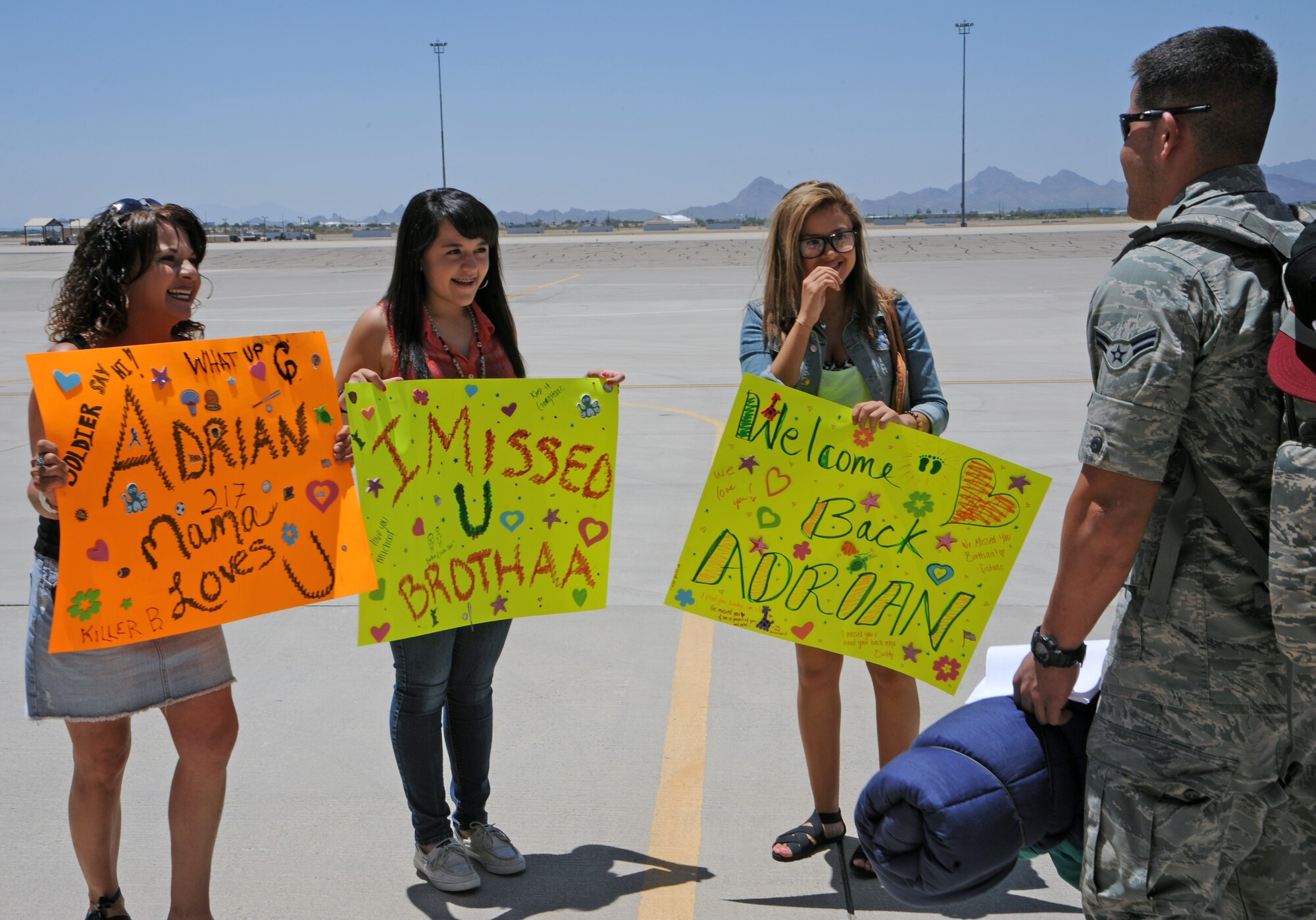 U.S. Air Force Airman 1st Class Diego Granillo, 923rd Aircraft Maintenance Squadron crew chief, is greeted by his loved ones after returning from a deployment at Davis-Monthan Air force Base, Ariz., June 4, 2012. Members of the 55th RQS have been constantly rotating deployments for the past three years. (U.S. Air Force photo by Airman 1st Class Camilla Griffin/Released)