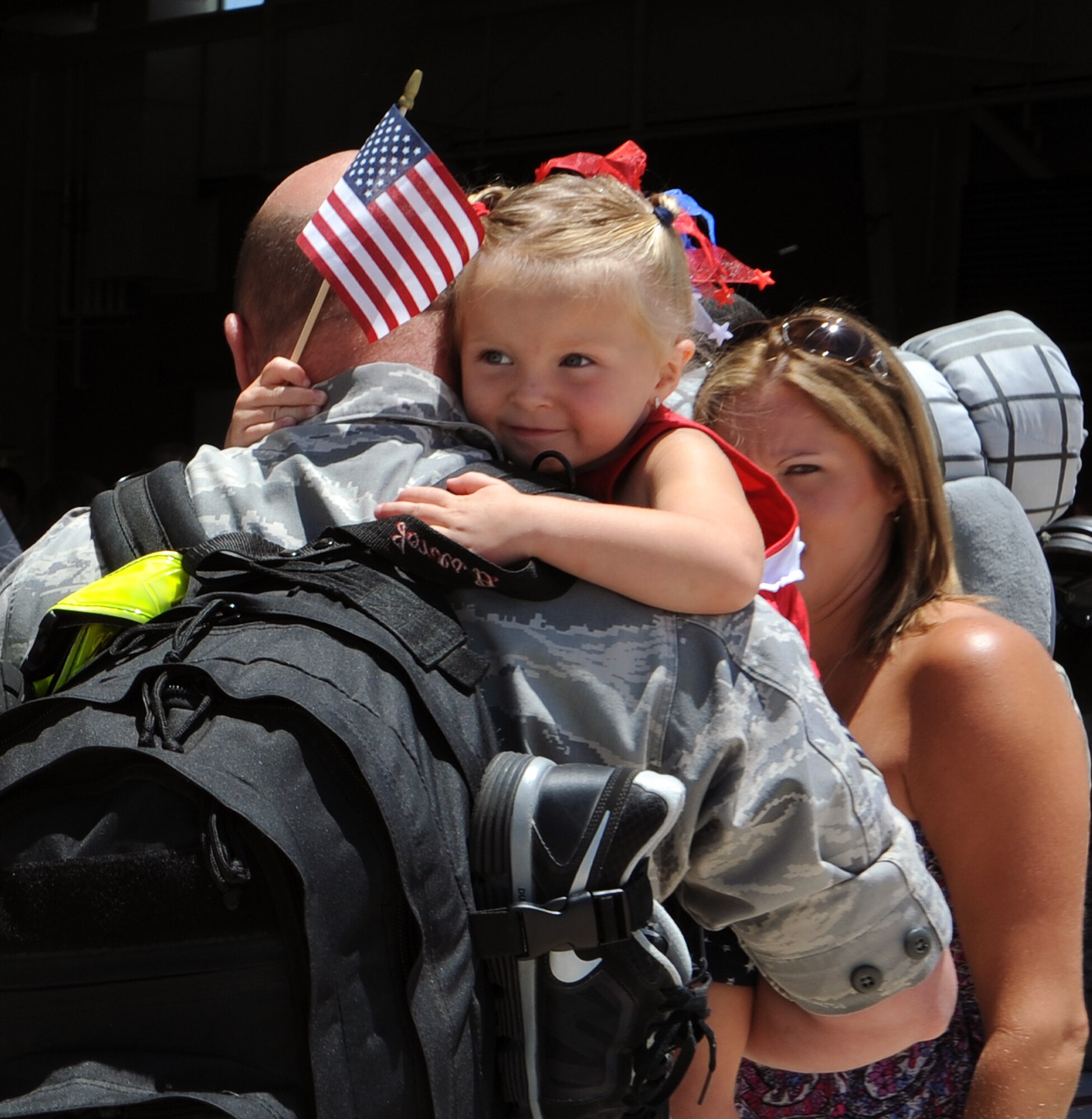 U.S. Air Force Tech. Sgt.  Douglas Jones, 923rd Aircraft Maintenance Squadron assistant weapons section chief, is welcomed home by his daughter, Ainsley Jones, three, from a deployment at Davis-Monthan Air force Base, Ariz., June 4, 2012. A deployed rescue squadron has a total of three hours to report to an alert, the 55th RQS has that time down to 25 minutes. (U.S. Air Force photo by Airman 1st Class Camilla Griffin/Released)