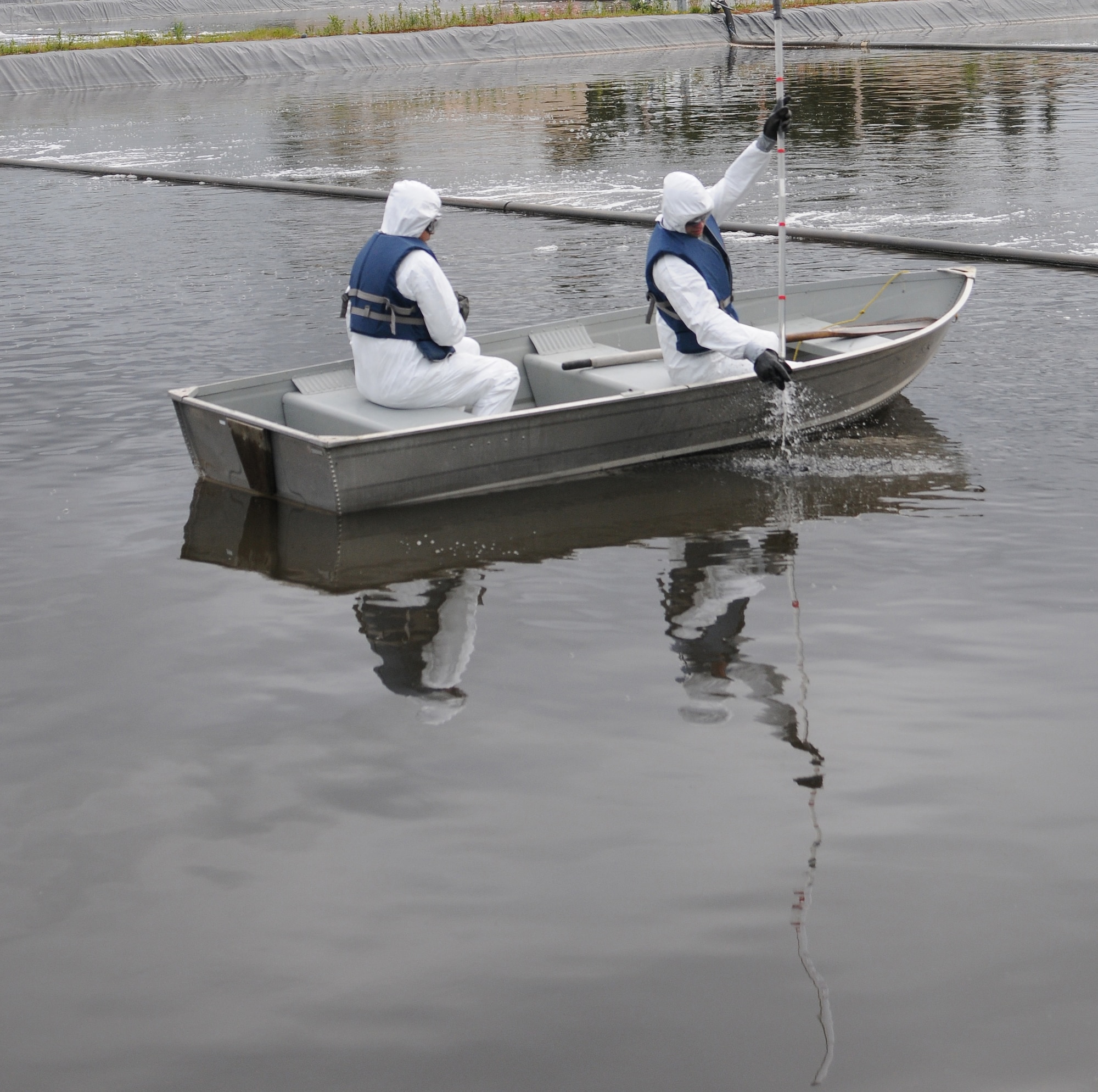 U.S. Air Force Airman 1st Class Derrick Statts, 354th Civil Engineer Squadron water treatment plant operator, releases waste material from a measuring pole to measure the sludge at the bottom June 1, 2012, Eielson Air Force Base, Alaska. The lagoons house bugs that feed on suspended solids aiding in the phase of water treatment.