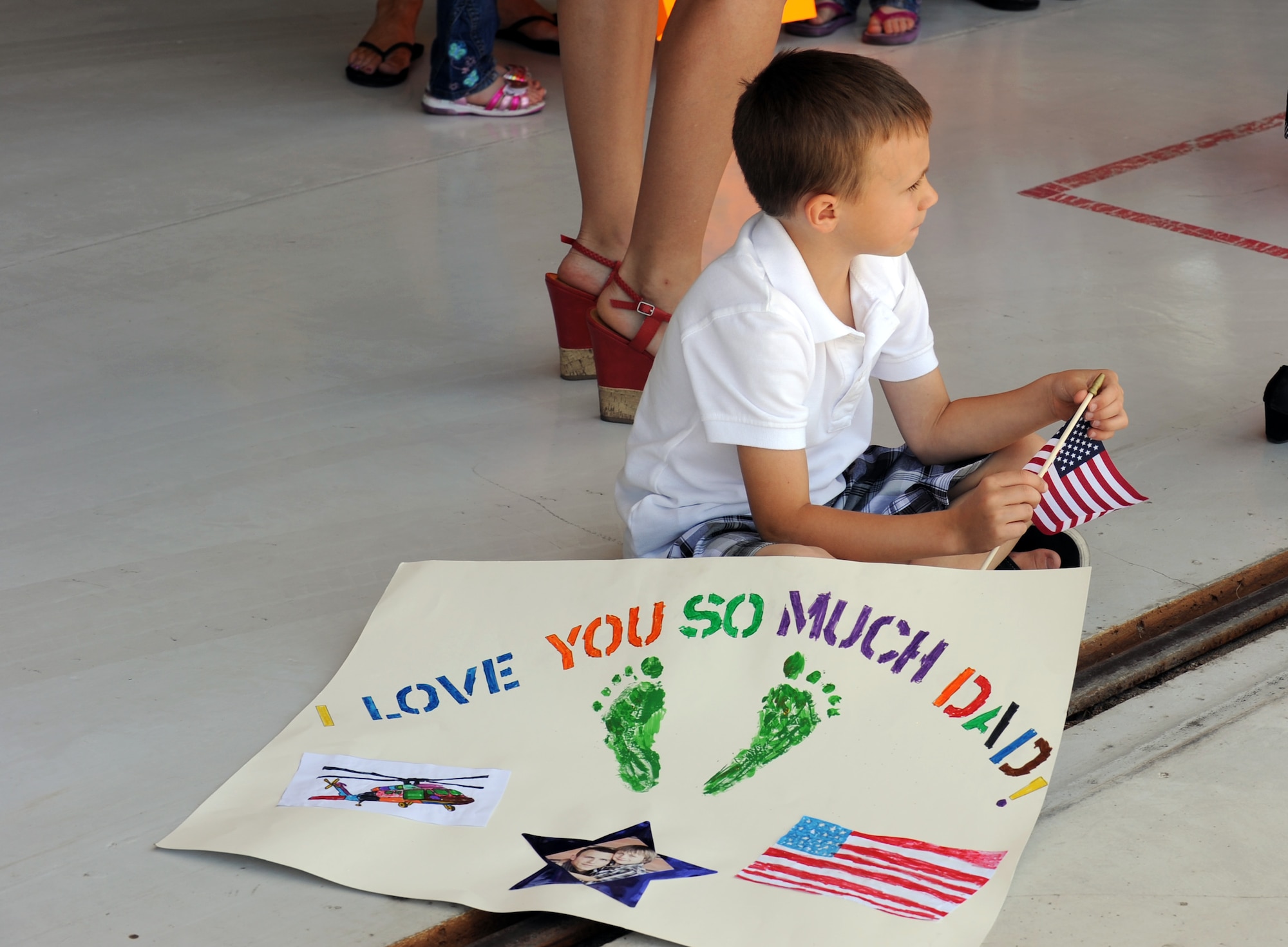 Eli Olson, six, waits for U.S. Air Force Staff Sgt. Jacob Olson, 923rd Aircraft Maintenance Squadron crew chief, to return from a deployment at Davis-Monthan Air force Base, Ariz., June 4, 2012. The 55th Rescue Squadron had more than 50 Airmen return from a 125-day deployment in Southwest Asia. (U.S. Air Force photo by Airman 1st Class Camilla Griffin/Released)