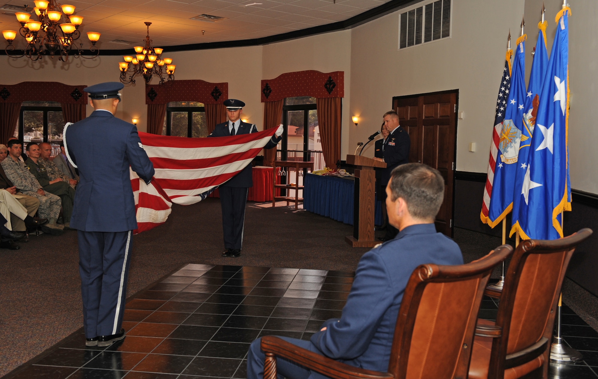 Members of the Barksdale Honor Guard prepare to fold the American flag during a retirement ceremony on Barksdale Air Force Base, La., May 18. During a retirement, the retiree will receive an American flag folded by the Honor Guard Airmen.  Honor Guard Airmen perform during retirements, funerals and many other military-related events out of respect for Air Force Airmen, both past and present. (U.S. Air Force photo/Airman 1st Class Benjamin Gonsier)(RELEASED)