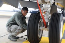Airman First Class Noel Rivera checks the tire pressure on a KC-135R Stratotanker. Rivera is a crew chief with the 916th Air Refueling Wing. (USAF photo by Staff Sgt. Mark Thompson, 916ARW/PA, released)