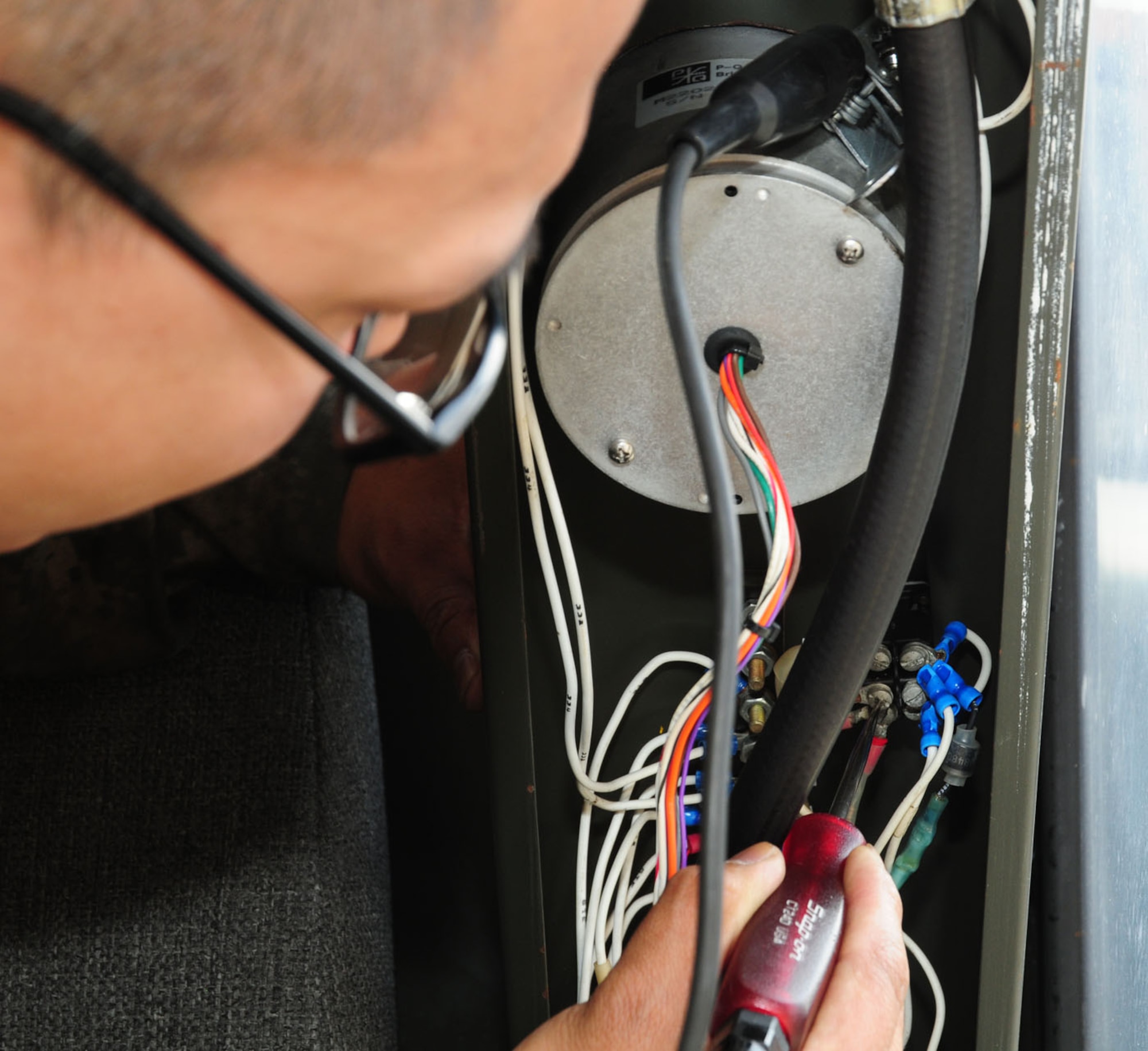 RAF MILDENHALL, England – Staff Sgt. Dan Coching, 100th Logistics Readiness Squadron Special Purpose Vehicle Maintenance, inspects the wiring on a deicer vehicle May 30, 2012. Coching is in charge of a team of Airmen working on the summer rebuild program on the deicing vehicles, which ensures all RAF Mildenhall’s winter-time equipment has preventive maintenance done, so the equipment is ready for winter. (U.S. Air Force photo/Karen Abeyasekere)