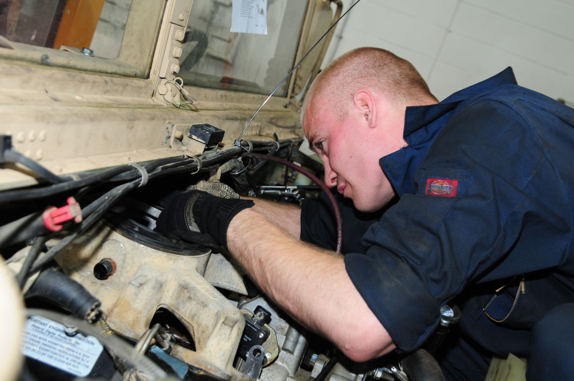 RAF MILDENHALL, England – Senior Airman Kane Goligoski, 100th Logistics Readiness Squadron Vehicle Maintenance, installs an intake manifold on a Humvee after replacing the cylinder head May 30, 2012. Vehicle maintenance personnel perform maintenance on a variety of government vehicles, with a fleet totalling more than 570. (U.S. Air Force photo/Karen Abeyasekere)