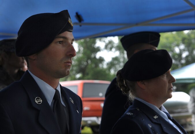 Staff Sgt. Brandon Edwards, 628th Security Forces dog handler, stands at attention during the graveyard service for Waldo at Joint Base Charleston - Air Base, S.C.  June 6, 2012. Waldo, a military working dog, was assigned to the 628th Security Forces Squadron and served most of his career here. He was deployed twice to Afghanistan. During his career, Waldo conducted 2,304 hours of searches and completed 425 hours of detection training. (U.S. Air Force photo/Airman 1st Class Ashlee Galloway) 
