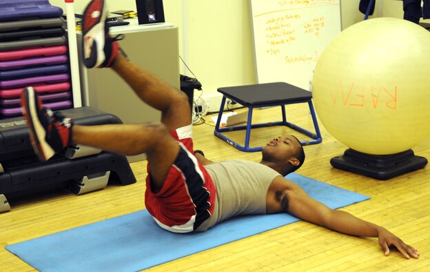 RAF MILDENHALL, England – Ronnie Drake, 100th Force Support Squadron, demonstrates how to execute a proper flutter kick during the Sit-up and Push-up Improvement class May 31, 2012, at North Side Fitness Center here. The class teaches a variety of strength training exercises to help improve an individual’s sit-ups and push-ups. The class is taught every Tuesday and Thursday from 5 to 6 p.m. at the North Side Fitness Center. (U.S. Air Force photo/Senior Airman Rachel Waller)