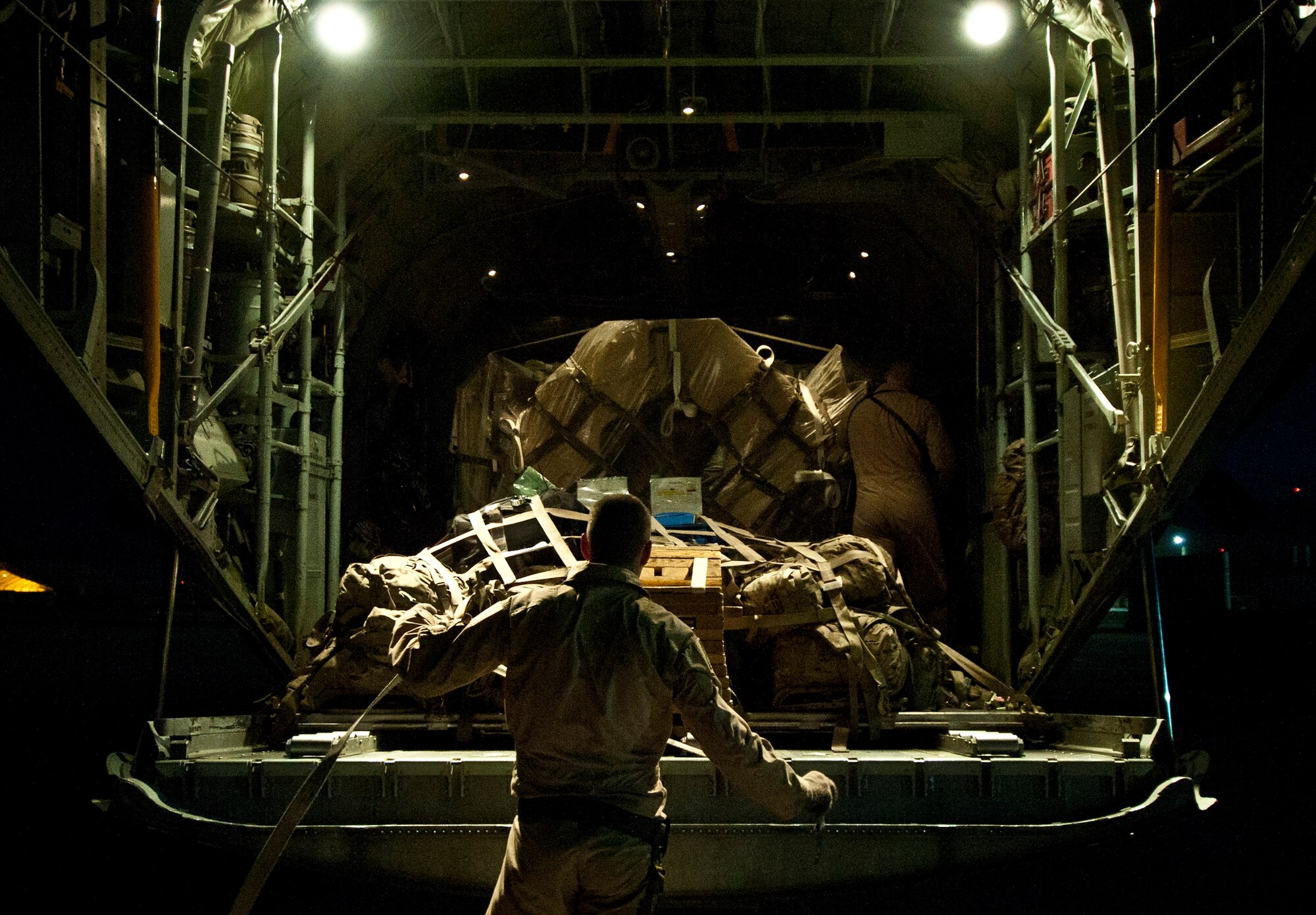 Airman 1st Class Tristian Lyons, loadmaster deployed to the 774th Expeditionary Airlift Squadron, secures a pallet of cagro aboard a U.S. Air Force C-130H Hercules at Bagram Airfield, Afghanistan, June 2, 2012. Bagram provides dedicated tactical airlift support to ground forces operating in Afghanistan. (U.S. Air Force photo/Capt. Raymond Geoffroy)
