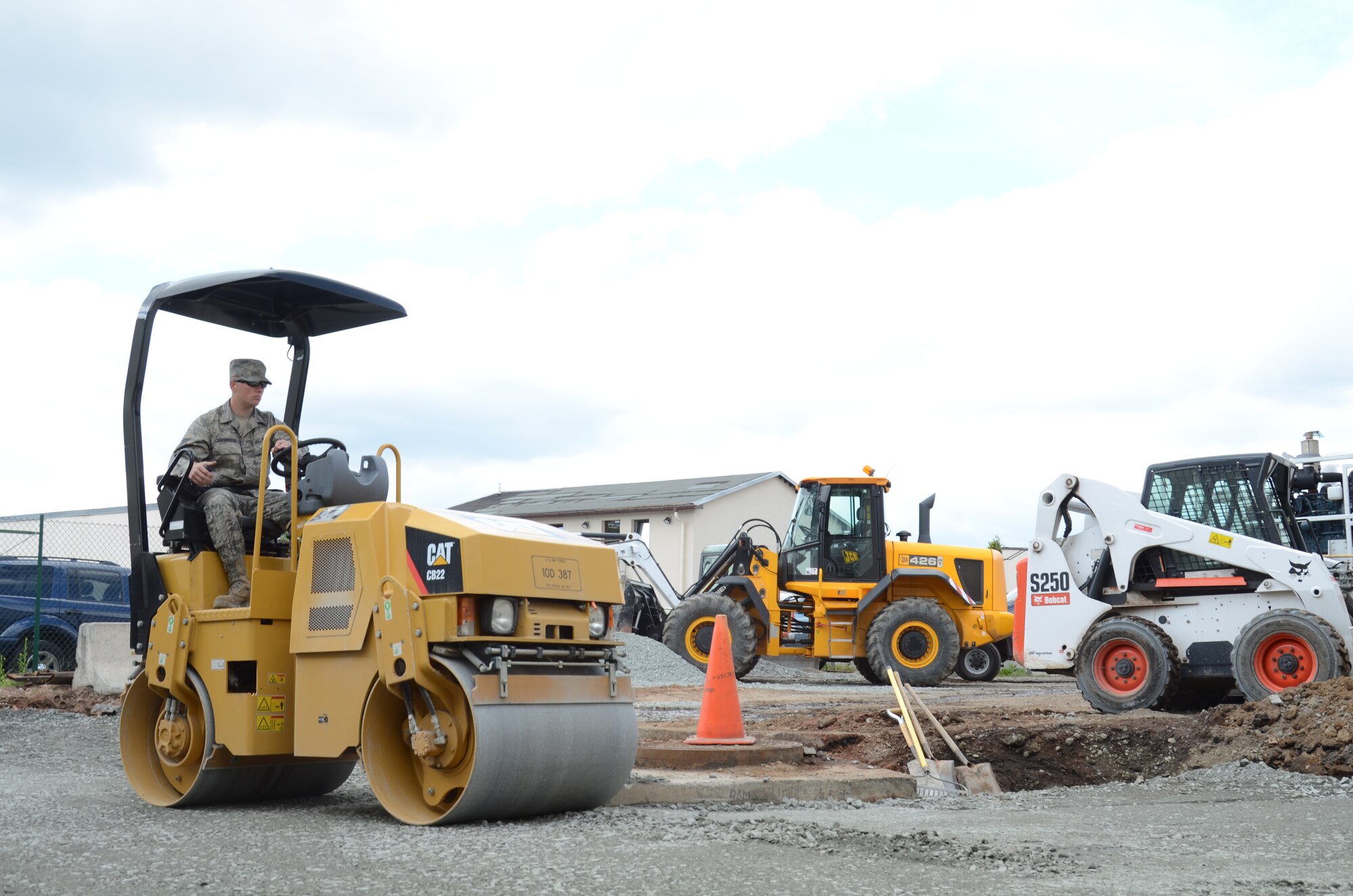 Senior Airman Logan Chambers, 786th Civil Engineering Squadron heavy equipment operator, paves the ground at a base facility here June 5. As part of the heavy equipment section of the 786th CES, Chambers helps maintain, construct and repair 1.2 million square meters of pavement around the Kaiserslautern Military Community. (U.S. Air Force Photo / 2nd Lt. Kay M. Nissen)