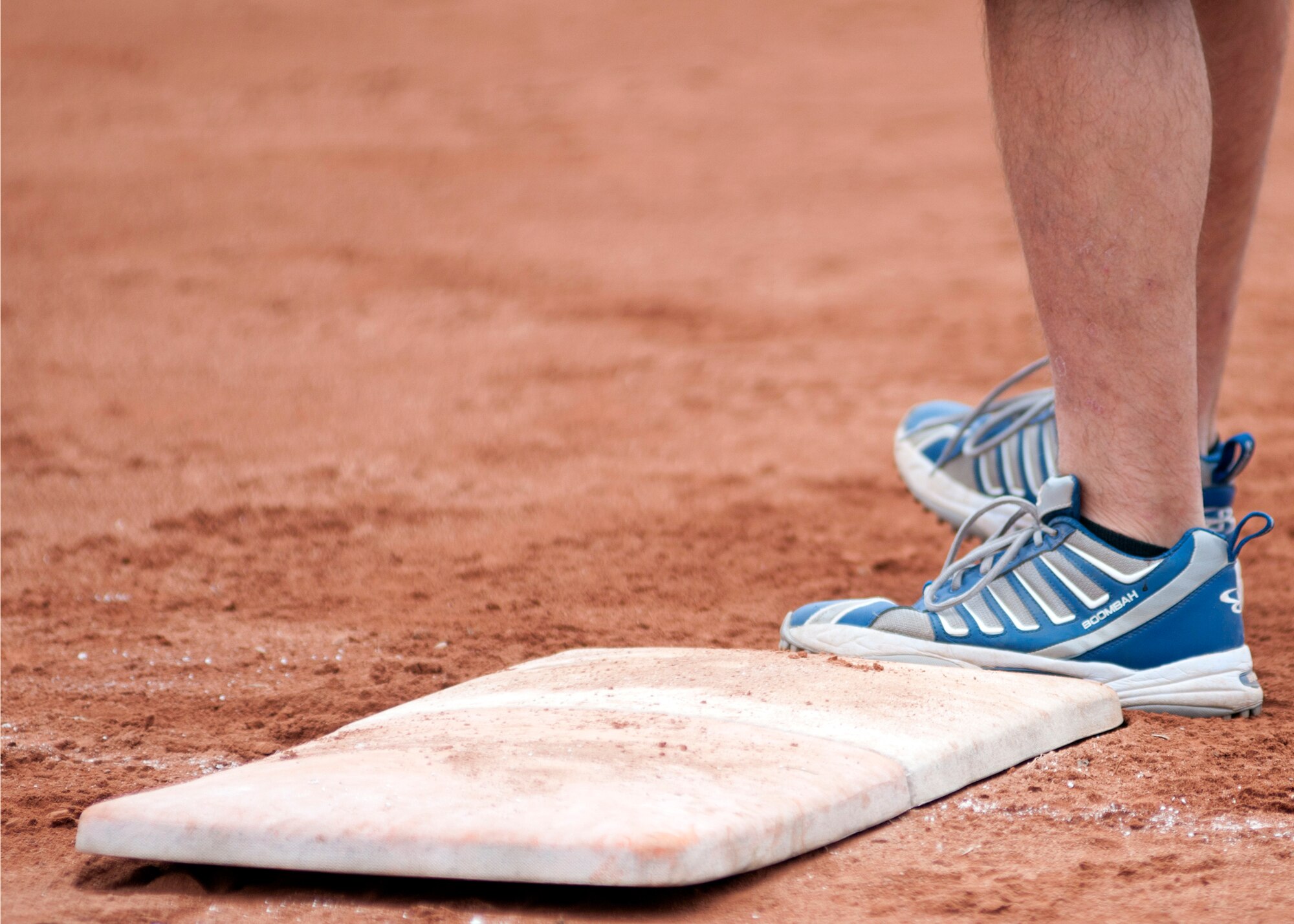 A ballplayer mans first base during a softball game between the 31st Security Forces and 31st Dental Squadrons June 1 at Aviano Air Base, Italy. A 31st Fighter Wing sports day was hosted by the 31st Force Support Squadron and assisted by 66 base volunteers, the all-day event was put together to give the wing a chance to unwind and engage with each other through various physical fitness activities. (U.S. Air Force photo/Airman 1st Class Briana Jones)