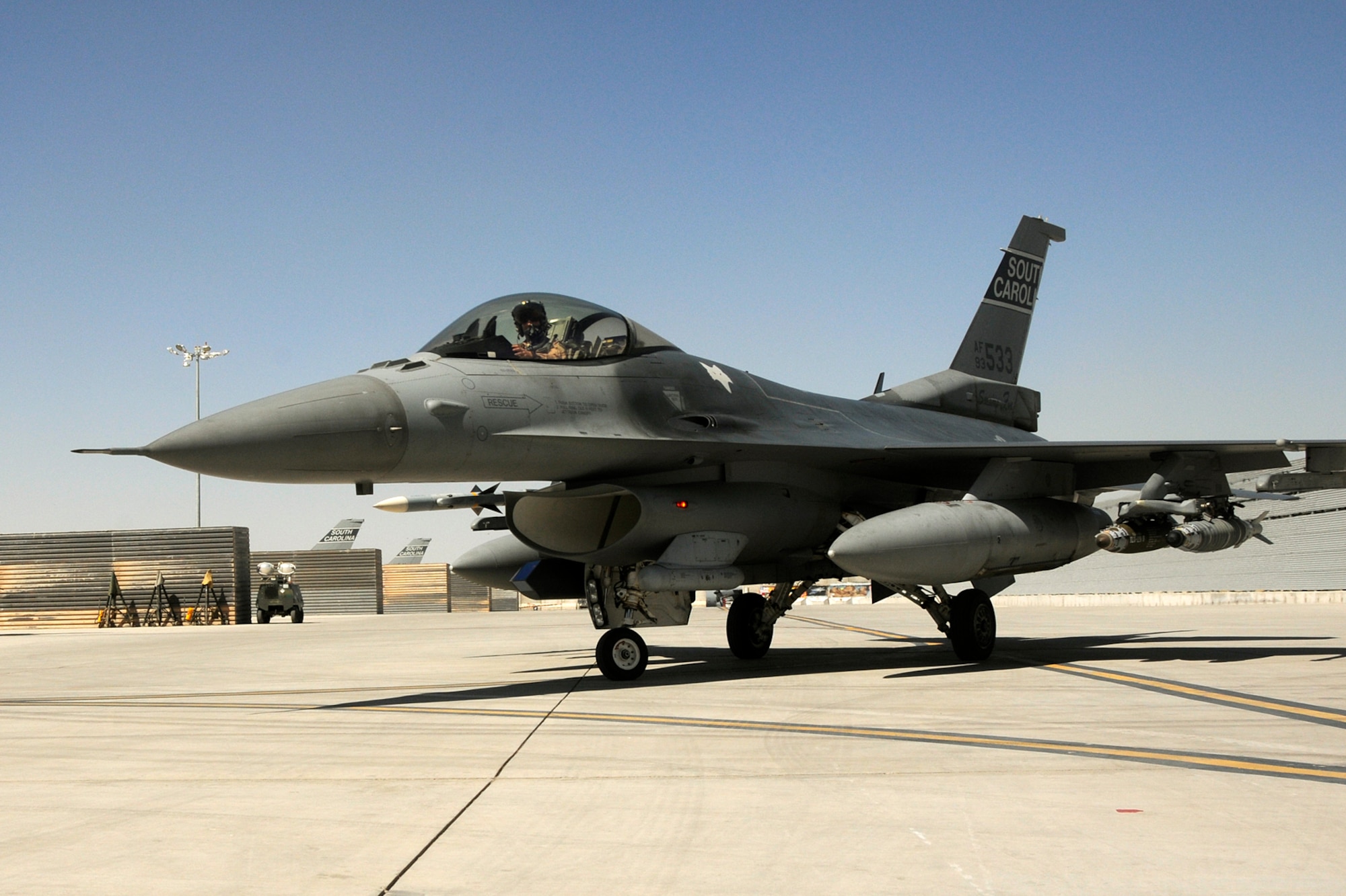 Lieutenant Colonel Scott Bridgers, a fighter pilot assigned to the 157th Expeditionary Fighter Squadron at Kandahar Airfield, Afghanistan, taxis an F-16 Fighting Falcon onto the flight line after flying a mission and reaching his 4,000th flying hour June 2, 2012. Lt. Col. Bridgers is the third fighter pilot to have achieved that level of flying from McEntire Joint National Guard Base, S.C.. Swamp Fox F-16's, pilots, and support personnel began their Air Expeditionary Force deployment early April to take over flying missions for the air tasking order and provide close air support for troops on the ground in Afghanistan in support of Operation Enduring Freedom.
(U.S. Air Force photo/TSgt. Caycee Cook)

