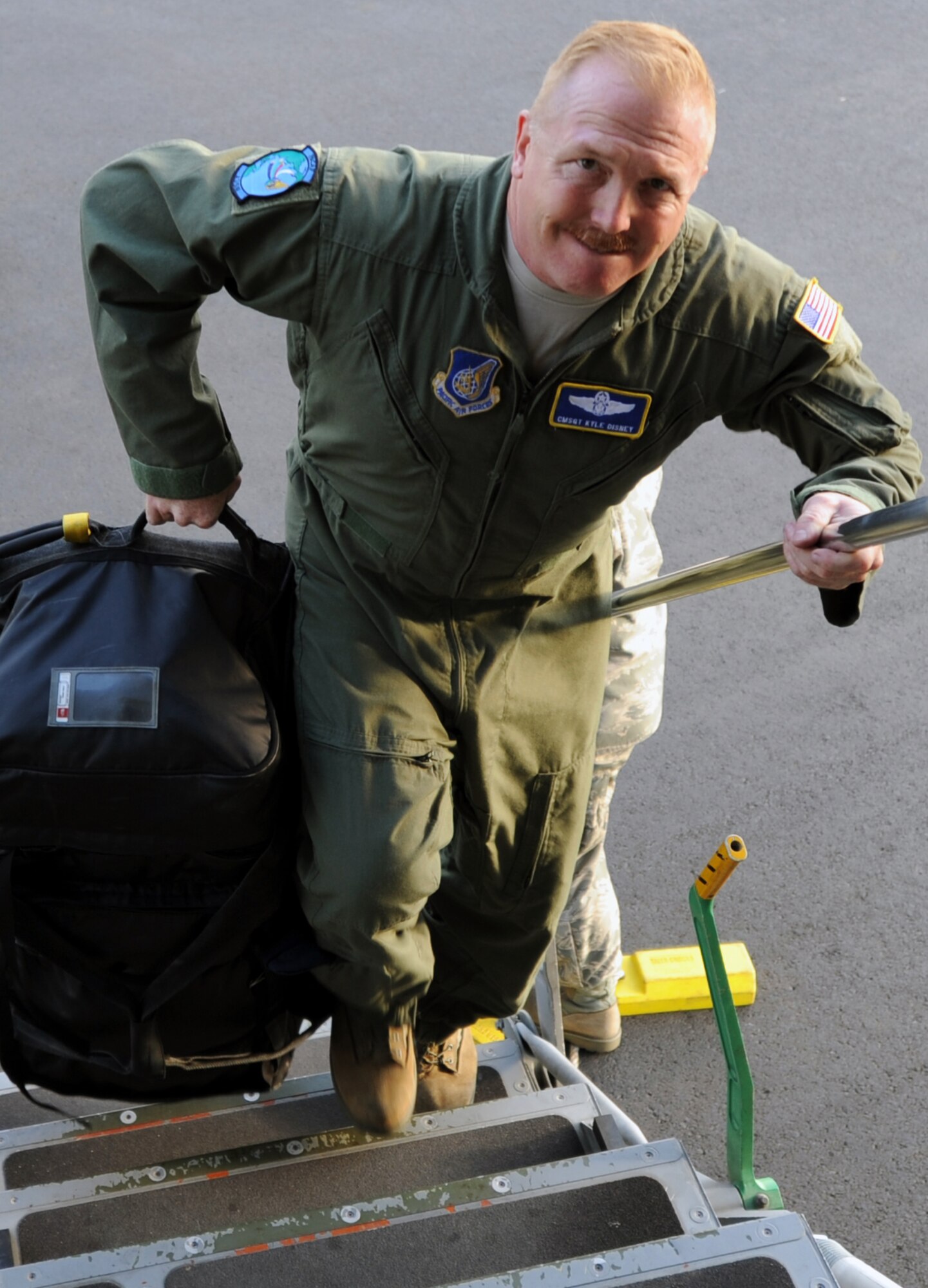 Chief Master Sgt. Kyle Disney, Headquarters Pacific Air Forces loadmaster standardizations and evaluations, loads luggage onto an awaiting 535th Airlift Squadron C-17 Globemaster III from Joint Base Pearl Harbor-Hickam, Hawaii, in preparation for an early morning departure to Alaska June 6 for the RED FLAG-Alaska military exercise. RED FLAG-Alaska is one of the largest international air-combat employment exercises in the world and is designed to test the specific capabilities of the military units that take part in the exercise and increase their chance of survival during actual combat. (U.S. Air Force photo by Capt. Ben Sakrisson)