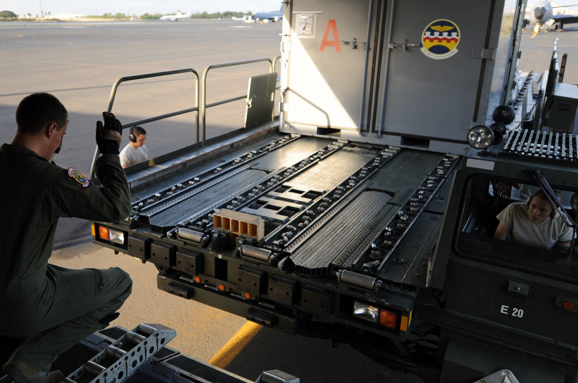 Amn. Jacob Willemborg, a loadmaster from the 535th Airlift Squadron at Joint Base Pearl Harbor-Hickam, Hawaii, guides a K-loader carrying cargo for a C-17 Globemaster III deploying to Alaska June 6 for the RED FLAG-Alaska military exercise. RED FLAG-Alaska is one of the largest international air-combat employment exercises in the world and is designed to test the specific capabilities of the military units that take part in the exercise and increase their chance of survival during actual combat. (U.S. Air Force photo by Capt. Ben Sakrisson)