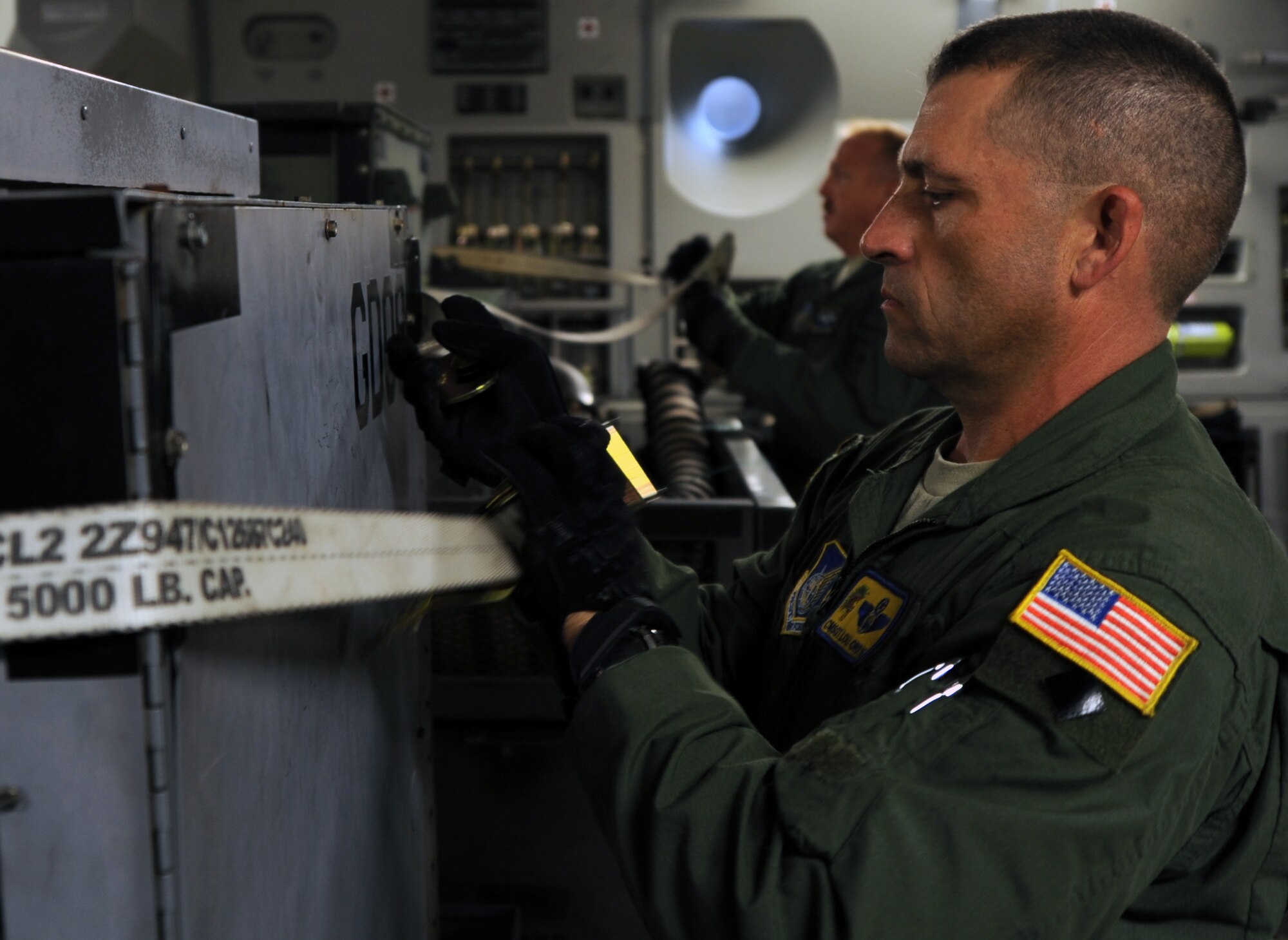 Chief Master Sgt. Lou Orrie, the 15th Operations Group superintendant at Joint Base Pearl Harbor-Hickam, Hawaii, secures aerospace ground equipment into place aboard a 535th Airlift Squadron C-17 Globemaster III aircraft preparing to deploy to Alaska June 6 for the RED FLAG-Alaska military exercise. RED FLAG-Alaska is one of the largest international air-combat employment exercises in the world and is designed to test the specific capabilities of the military units that take part in the exercise and increase their chance of survival during actual combat. (U.S. Air Force photo by Capt. Ben Sakrisson)
