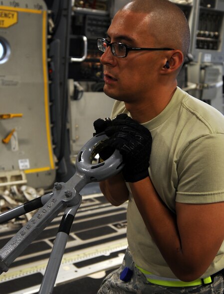 Sgt. Makai Estioko, an aerospace ground equipment mechanic from the 15th Maintenance Group at Joint Base Pearl Harbor-Hickam, Hawaii, loads a B5 maintenance stand onto a 535th Airlift Squadron C-17 Globemaster III aircraft preparing to deploy to Alaska June 6 for the RED FLAG-Alaska military exercise. RED FLAG-Alaska is one of the largest international air-combat employment exercises in the world and is designed to test the specific capabilities of the military units that take part in the exercise and increase their chance of survival during actual combat. (U.S. Air Force photo by Capt. Ben Sakrisson)