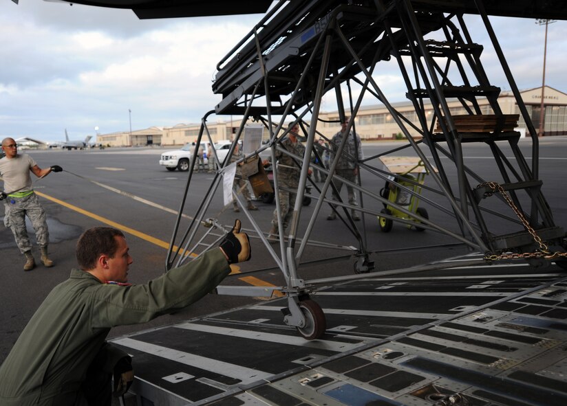 Amn. Jacob Willemborg, a loadmaster from the 535th Airlift Squadron at Joint Base Pearl Harbor-Hickam, Hawaii, oversees the loading of a maintenance stand onto a 535th Airlift Squadron C-17 Globemaster III aircraft preparing to deploy to Alaska June 6 for the RED FLAG-Alaska military exercise. RED FLAG-Alaska is one of the largest international air-combat employment exercises in the world and is designed to test the specific capabilities of the military units that take part in the exercise and increase their chance of survival during actual combat. (U.S. Air Force photo by Capt. Ben Sakrisson)