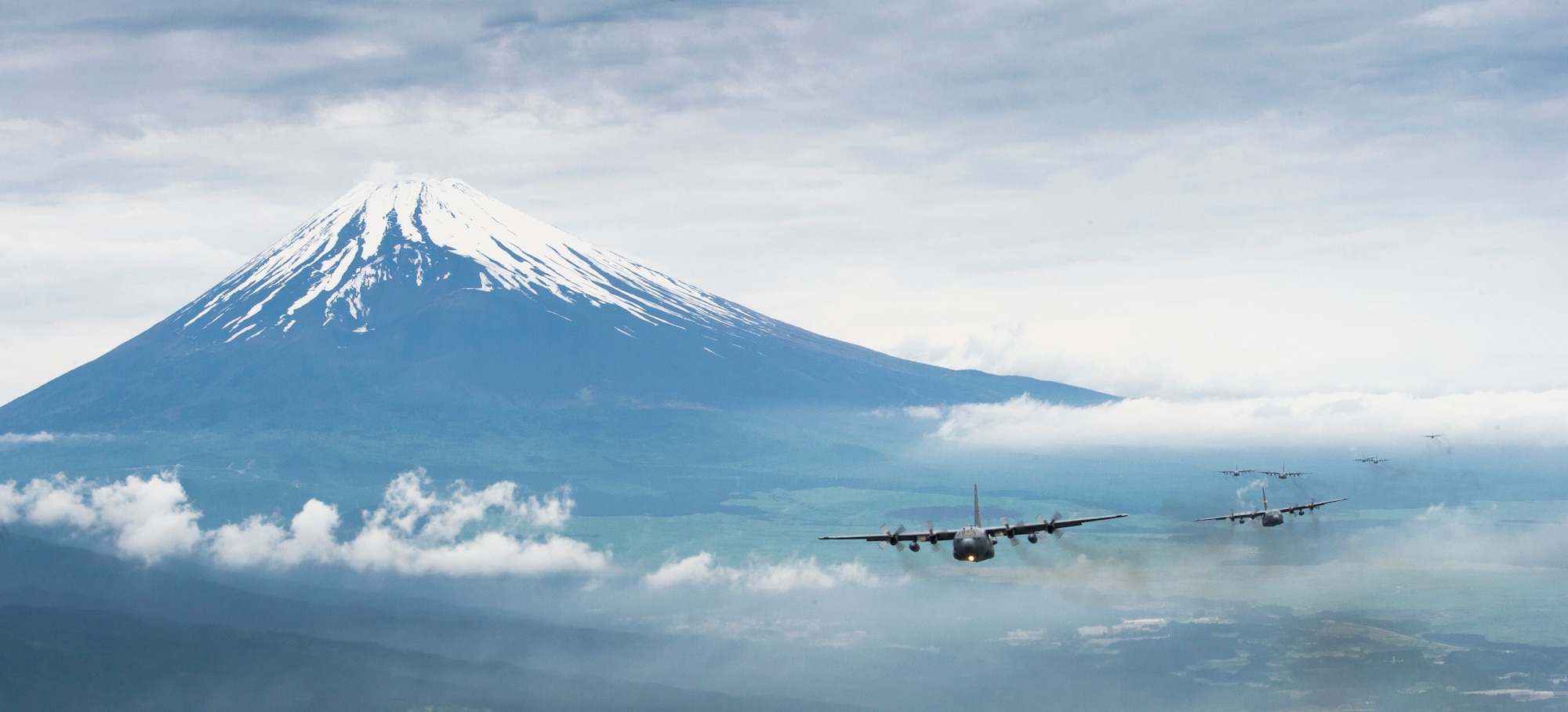YOKOTA AIR BASE, Japan -- A formation of C-130 Hercules cargo aircraft fly in formation as they return from a training mission near Mount Fuji, Japan, on June 5, 2012. At 12,388 feet, Mount Fuji is the tallest mountain in Japan. (U.S. Air Force photo by Staff Sgt. Chad C. Strohmeyer)
