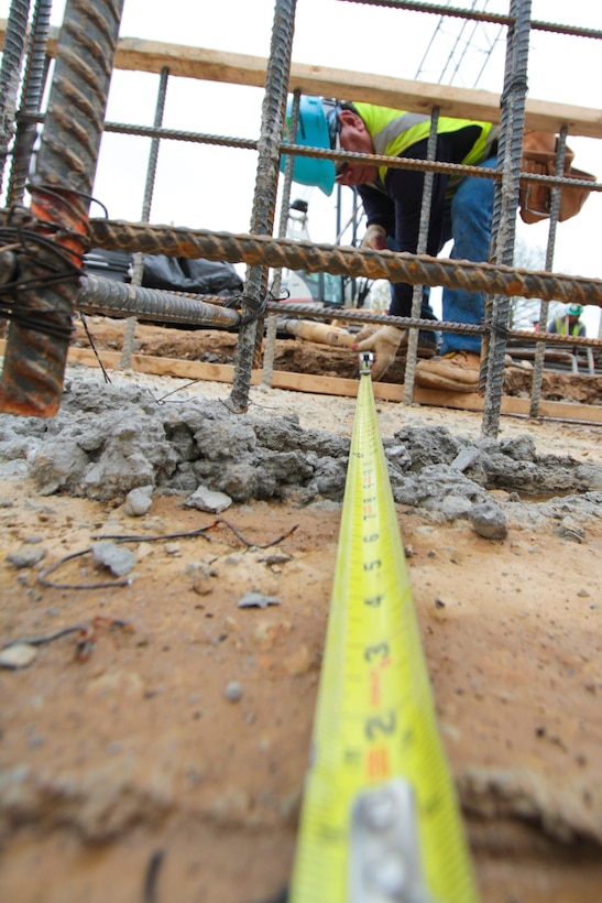 Leonel Alberto Giron, a contractor working on the Arlington National Cemetery columbarium number nine project, measures the width of the rebar support structure prior to pouring concrete. The new 62,640 square-foot facility will provide more than 20,000 niche spaces to inurn military and former military personnel who qualify for burial at the cemetery. (U.S. Army photo/Patrick Bloodgood)