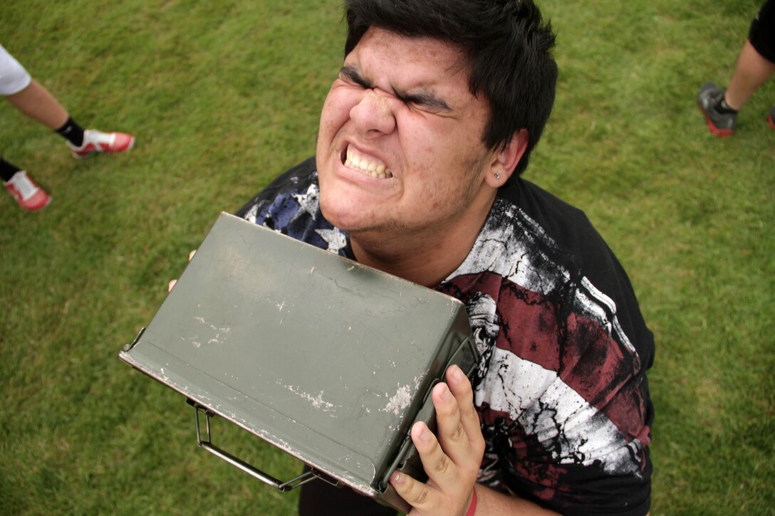 William Gonzalez completes one more ammo can lift during a modified combat fitness test at Henry Sibley High School June 8. More than 60 football players from Henry Sibley participated in the fitness challenge, which was hosted by Recruiting Substation Woodbury. The top performers from each of the three events were recognized for their efforts. For additional imagery from the event, visit www.facebook.com/rstwincities.