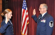 Master Sgt. Jim Clements, 446th Aerospace Medicine Squadron NCOIC of Optometry out of McChord Field, Wash. receives his oath of office for his last reenlistment in the Air Force Reserve from his daughter, new second lieutenant, Monica Clements, June 2, 2012. Although Jim is approaching 32 years in the military, Monica graduated from the Air Force Academy, Colorado Springs, Colo., May 23, 2012. (U.S. Air Force photo/Tech. Sgt. Elizabeth Moody) 