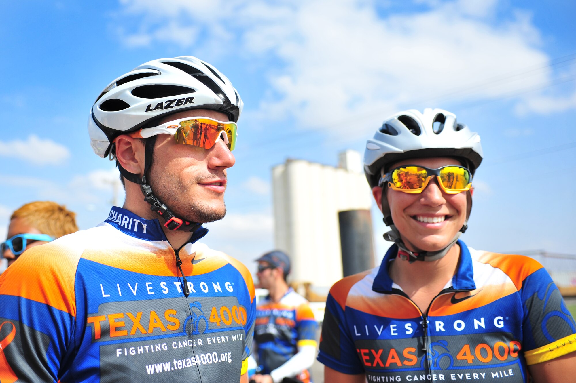 Two Texas 4000 cyclists stand near the New Mexico border just east of Clovis, N.M., after biking from Farwell, Texas, June 7, 2012. The Texas 4000 was founded in 2003 and is the longest annual charity bike ride in the world. (U.S. Air Force photo by Airman 1st Class Alexxis Pons Abascal)  