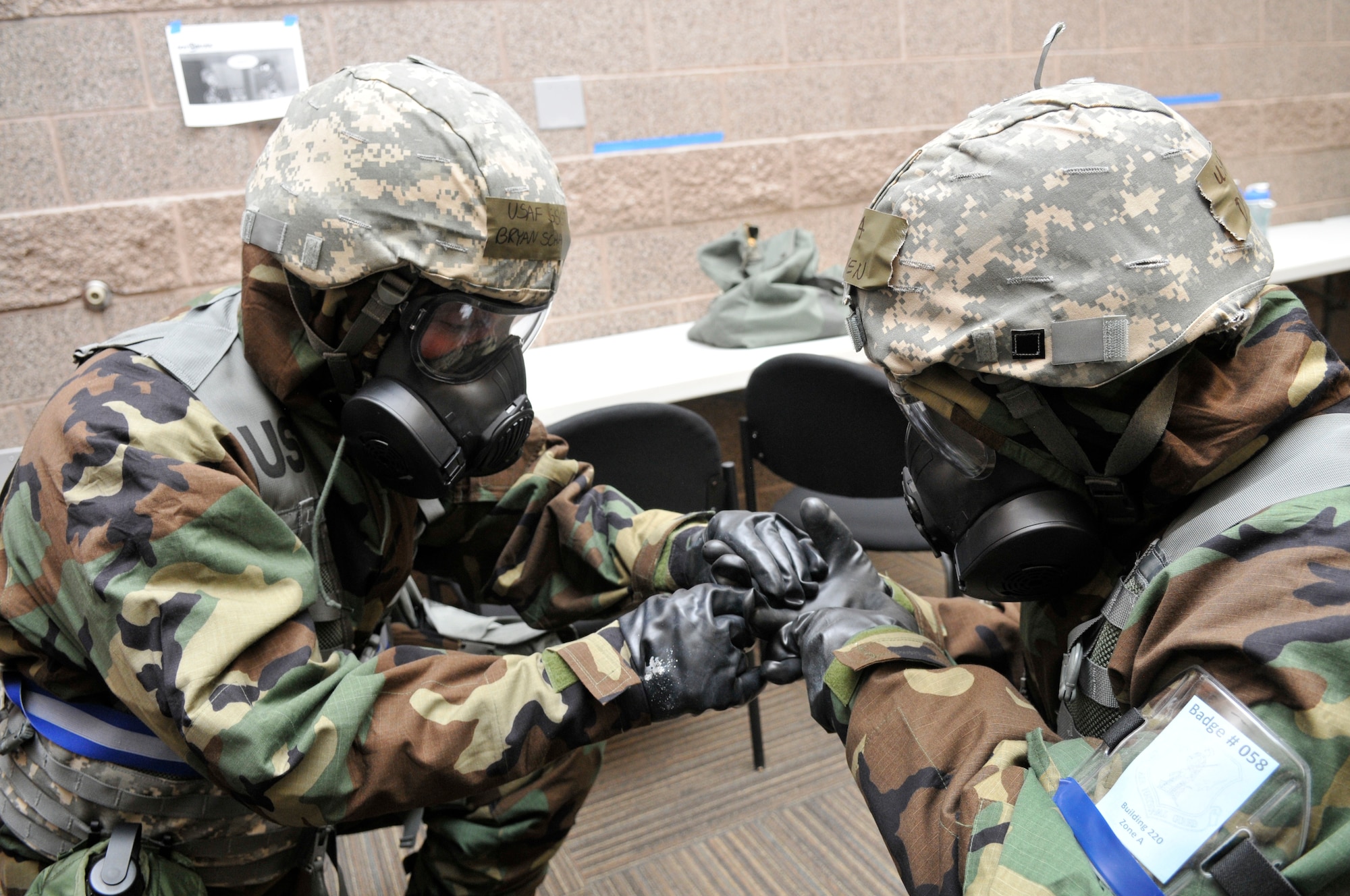 Airmen perform buddy checks during an Ability To Survive and Operate (ATSO) inspection. (U.S. Air Force photo by Tech. Sgt. Jeremy Giacoletto-Stegall)