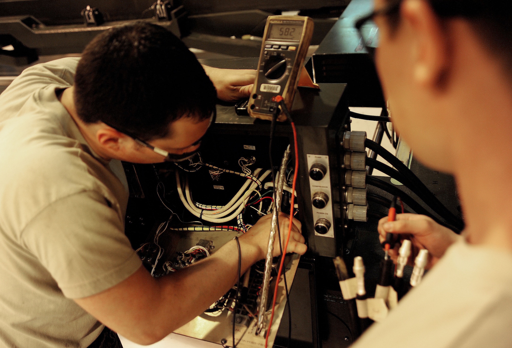 WHITEMAN AIR FORCE BASE, Mo. -- Senior Airman Coty Cloud, 509th MXS Aerospace Ground Equipment journeyman, and Airman 1st Class James McQueen, 509th Maintenance Squadron Aerospace Ground Equipment apprentice, inspect a power control box on an MHU-204 Munitions Lift Trailer before performing maintenance May 31, 2012. This inspection ensures the connection from the cable to the inspection control box is secure. (U.S. Air Force photo/Senior Airman Nick Wilson) (Released)