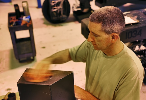 WHITEMAN AIR FORCE BASE, Mo. -- Tech. Sgt. Kevin Radford, 131st Maintenance Squadron Aerospace Ground Equipment technician, cleans panels on a piece of equipment before a final inspection May 31, 2012. Radford inspects, tests and operates AGE to determine equipment serviceability and proper operation. (U.S. Air Force photo/Senior Airman Nick Wilson) (Released)