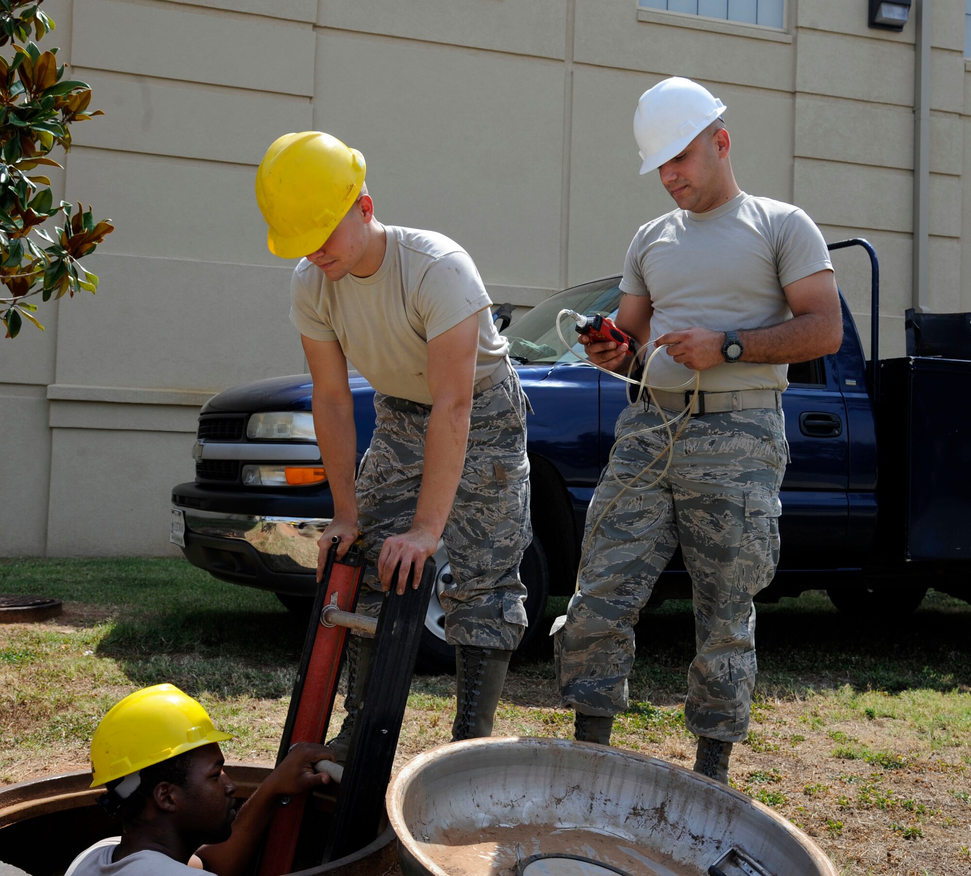 Senior Airman Bryon McMillan, Airman 1st Class Matthew Gamble and Staff Sgt. Pedro Estrada, 2nd Communications Squadron, head underground to inspect a 1,200-pair communications cable on Barksdale Air Force Base, La., June 8. The Airmen conducted routine maintenance checks on the cable to check for possible damage. (U.S. Air Force photo/Airman 1st Class Andrew Moua)(RELEASED)
