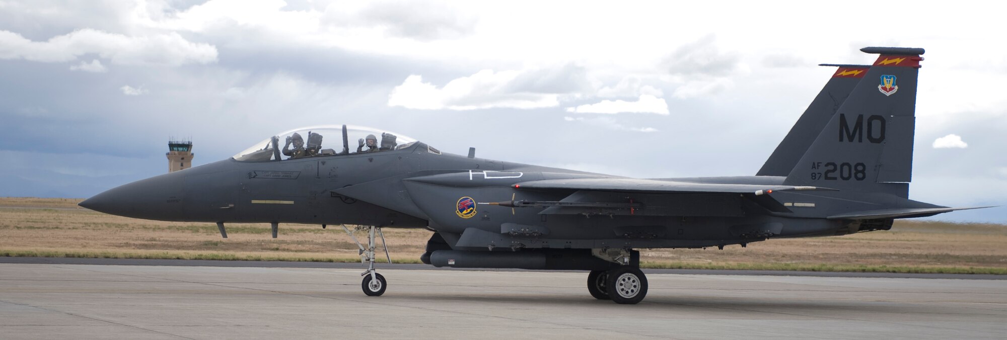 U.S. Air Force Lt. Col. Paul Hibbard, 389th Fighter Squadron, and third year Air Force Cadet Aaron M. Hall, wave as they taxi down for final checks before take-off, June 5, 2012, at Mountain Home Air Force Base, Idaho. The F-15E Strike Eagle is an all-weather, multirole fighter, and the work horse of Mountain Home Air Force Base. (U.S. Air Force photo/Airman 1st Class Jonathan Glanville)