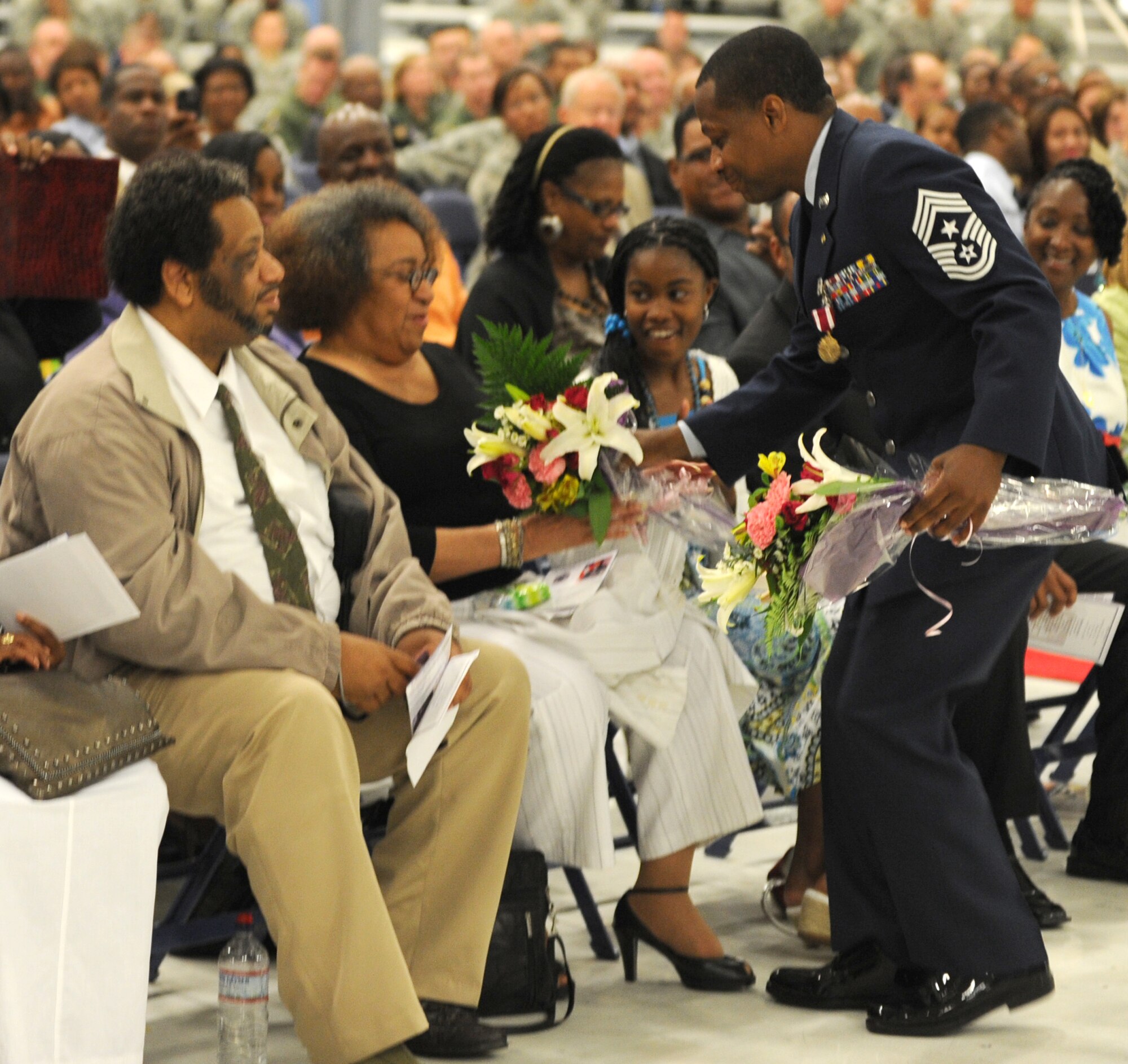 Chief Master Sgt. Anthony Brinkley, 11th Wing/Joint Base Andrews command chief, presents his mother with a bouquet of flowers during his retirement ceremony June 8, 2012. Brinkley served more than 28 years in the Air Force.  (U.S. Air Force Photo by Staff Sgt. Torey Griffith)