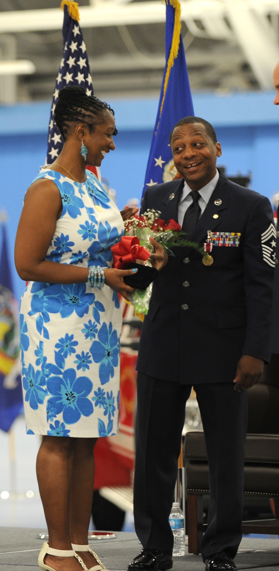 Chief Master Sgt. Anthony Brinkley, 11th Wing/Joint Base Andrews command chief, presents his wife with a bouquet of flowers during his retirement ceremony June 8, 2012. Brinkley served more than 28 years in the Air Force.  (U.S. Air Force Photo by Staff Sgt. Torey Griffith)