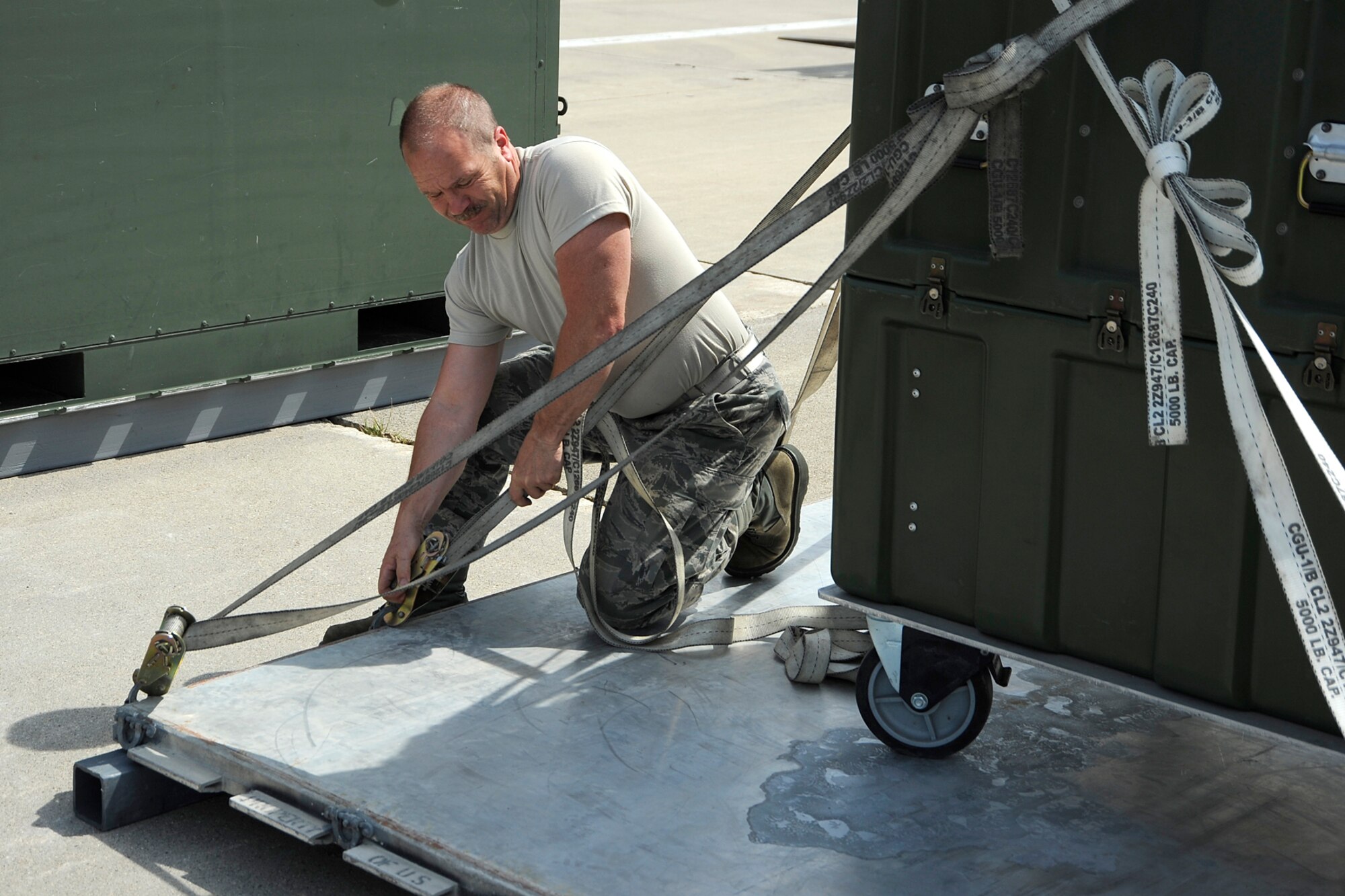 Airmen from the 127th Wing reload cargo placed in individuals shipping units (ISUs) from a C-130 to a KC-135 to ship to Estonia on June 8, 2012, at Selfridge Air National Guard Base, Mich.  The cargo equipment is headed to Saber Strike 12, a US Army European command-led theater security cooperation exercise conducted in the Baltic States (Estonia, Latvia and Lithuania). The plane swap led to repacking the cargo into ISUs of a smaller size. (USAF photo by John S. Swanson)