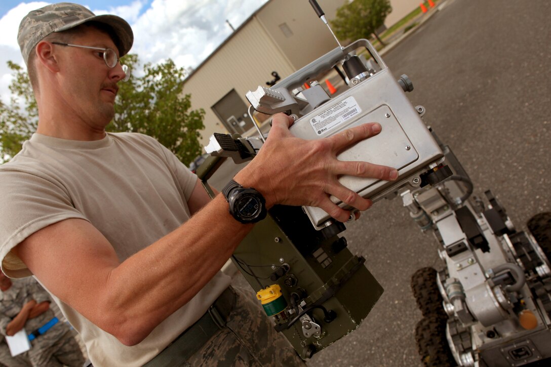Explosive Ordnance Disposal non-commissioned officer in charge Master Sgt. Ed Nickel loads an ANDROS F6A Explosive Ordnance Disposal robot during an exercise at the 177th Fighter Wing June 6, 2012. Airmen from the 177th along with New Jersey National Guard Soldiers and Airmen of the 21st Civil Support Team (Weapons of Mass Destruction), South Jersey Transit Authority firefighters and New Jersey State Police responded to a simulated weapons of mass destruction incident.  Members of the 177th Explosive Ordnance Disposal team worked with the 21st CST in reacting to a simulated explosion on base. The 21st CST supports civil authorities by responding to a weapons of mass destruction (WMD) situation. The unit is made up of full-time New Jersey Army and Air National Guard members that have been trained and equipped to provide support to civil authorities at a domestic chemical, biological, radiological, nuclear and high-explosive (CBRNE) incident site by identifying CBRNE agents/substances, assessing current and projected consequences and advising on response measures and assisting with appropriate requests for state support.  U.S. Air Force photo by Master Sgt. Mark C. Olsen