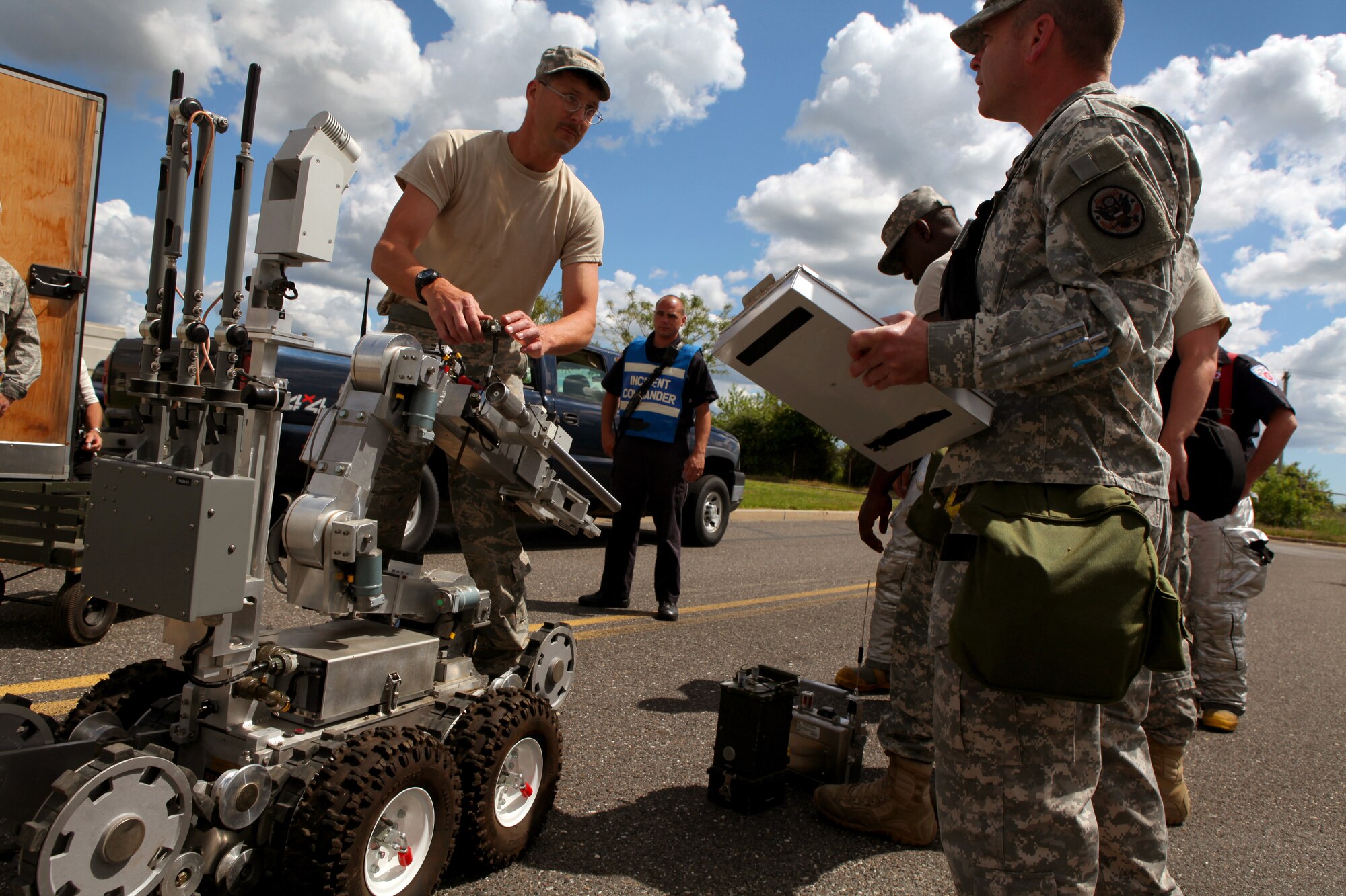 A picture of Explosive Ordnance Disposal non-commissioned officer in charge Master Sgt. Ed Nickel pausing while loading an ANDROS F6A Explosive Ordnance Disposal robot.