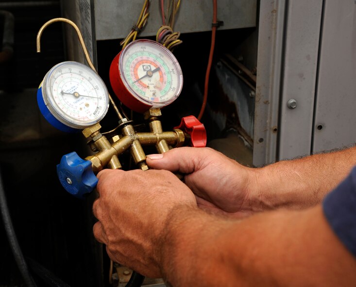 Ray O'Briant, 2nd Civil Engineer Squadron Heating, Ventilation, Air Conditioning and Refrigeration air conditioning equipment mechanic, monitors pressure levels on an air compressor on Barksdale Air Force Base, La., June 7. O'Briant found a leak on the compressor during a routine check on the base's air systems. Pre-emptive maintenance like this can prevent more serious problems from occurring. (U.S. Air Force photo/Airman 1st Class Andrew Moua)(RELEASED)
