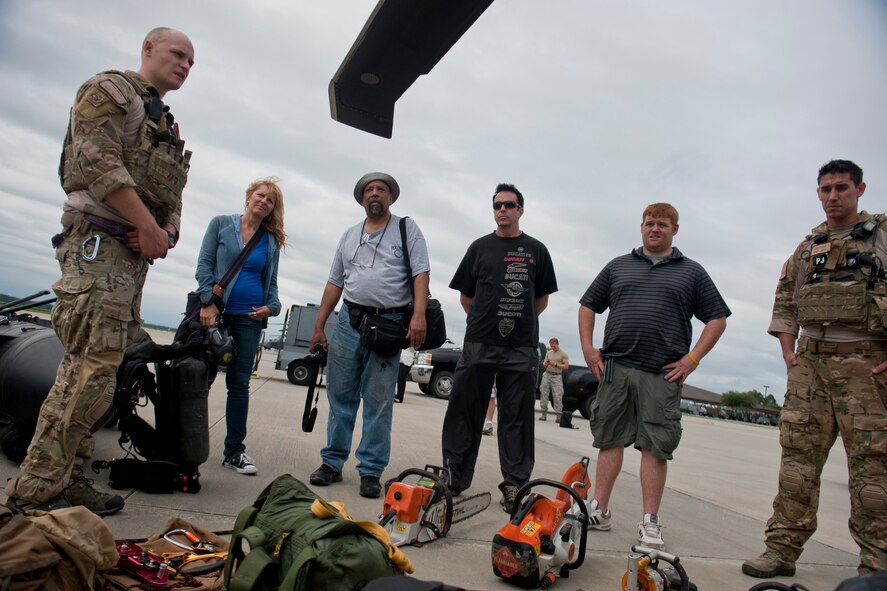 U.S. Air Force Staff Sgt. Ryan Onley, 38th Rescue Squadron pararescueman, showcases equipment used by his unit to U.S. Air Force Art Program artists during their tour of Moody Air Force Base, Ga., June 8, 2012. The Art Program documents Air Force history by highlighting Airmen and their actions through various art forms. The artists visited Moody to gain inspiration for future paintings. (U.S. Air Force photo by Staff Sgt. Jamal D. Sutter/Released) 