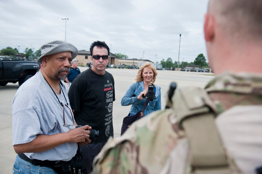 Charles Lilly, Lee Bivens and Mia Tavanotti, U.S. Air Force Art Program artists, speak with U.S. Air Force Staff Sgt. Ryan Onley, 38th Rescue Squadron pararescueman, about his career field June 8, 2012, at Moody Air Force Base, Ga. The artists visited to get better knowledge of Moody’s mission and to gain inspiration for future paintings incorporating Moody’s Airmen and assets. (U.S. Air Force photo by Staff Sgt. Jamal D. Sutter/Released) 