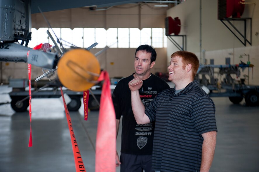 Lee Bivens, U.S. Air Force Art Program artist, left, and Greg Hood, 98 Rock Morning Show assistant producer from Baltimore, view an A-10C Thunderbolt II during a tour of Moody Air Force Base, Ga., June 8, 2012. Bivens is one of three artists who visited Moody to gain inspiration for future paintings. Hood accompanied the artists and provided daily updates on the visit for his radio show. (U.S. Air Force photo by Staff Sgt. Jamal D. Sutter/Released)  