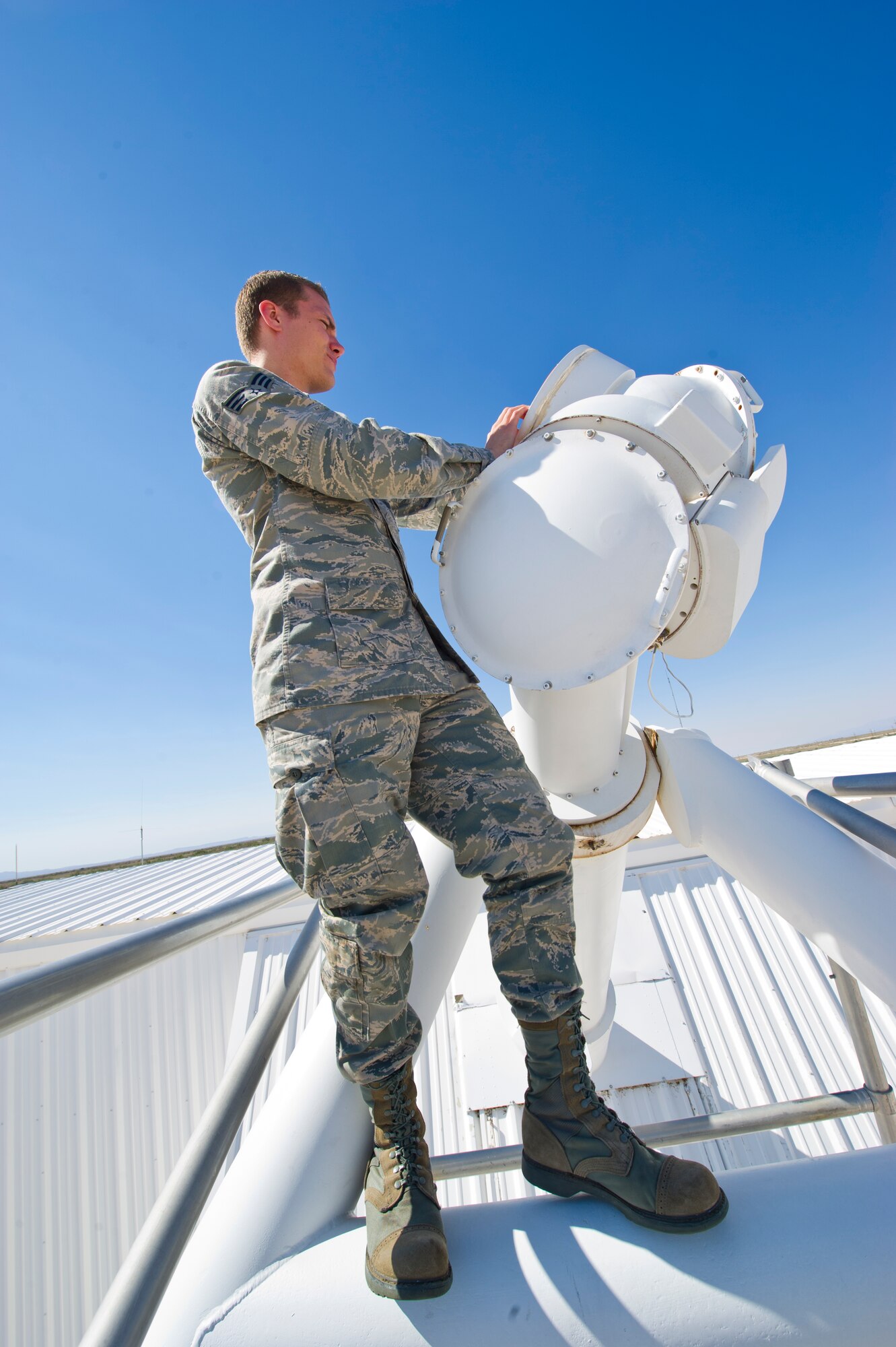 Senior Airman Erin O’Connell, Detachment 4, 2nd Weather Squadron solar analyst, changes the filter on an objective lens used to observe the sun at the Holloman Air Force Base, N.M., solar observatory June 7. The objective lens is designed to follow the sun throughout all periods of the day, allowing analysts to observe any fluctuations that may impact space operations. (U.S. Air Force photo by Airman 1st Class Daniel E. Liddicoet/Released)