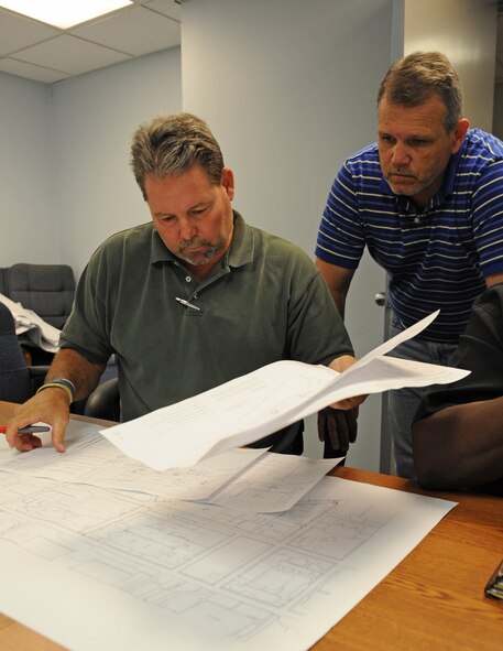 Tony Cyr, 2nd Civil Engineer Programming Flight chief, and Allen Spillers, 2 CES Programming Flight mechanical engineer, look through drawing plans of the base infrastructures on Barksdale Air Force Base, La., Jun 7. The 2 CES Programming Flight consists of engineers and an architect who design and review drawing plans of base infrastructures. (U.S. Air Force photo/Airman 1st Class Benjamin Gonsier)(RELEASED)