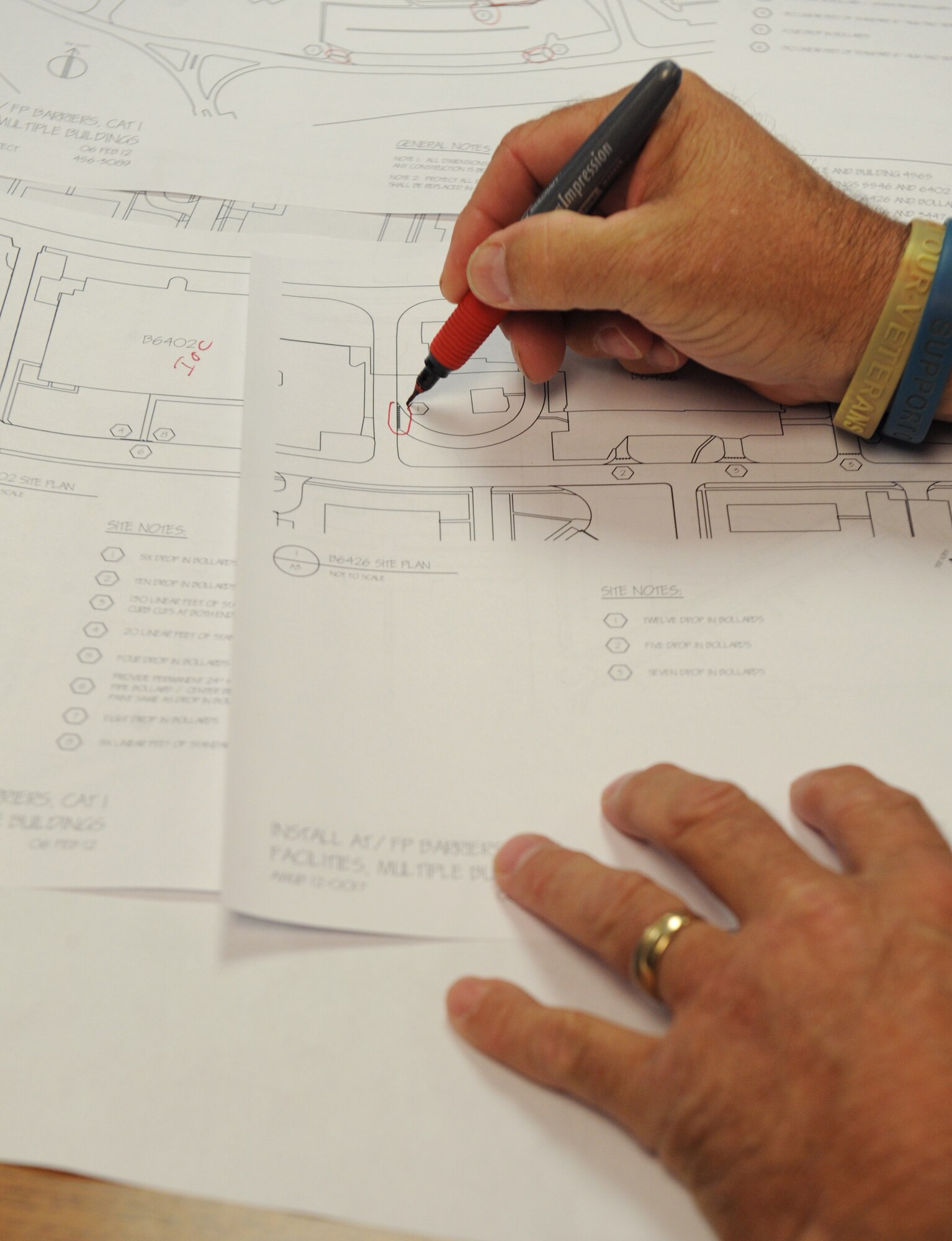 Tony Cyr, 2nd Civil Engineer Squadron Programming Flight chief, circles an area on a drawing plan on Barksdale Air Force Base, La., June 7. The 2 CES Programming Flight consists of engineers and an architect who design and review drawing plans of base infrastructures. The section also reviews all renovation and demolition projects on base. (U.S. Air Force photo/Airman 1st Class Benjamin Gonsier)(RELEASED)