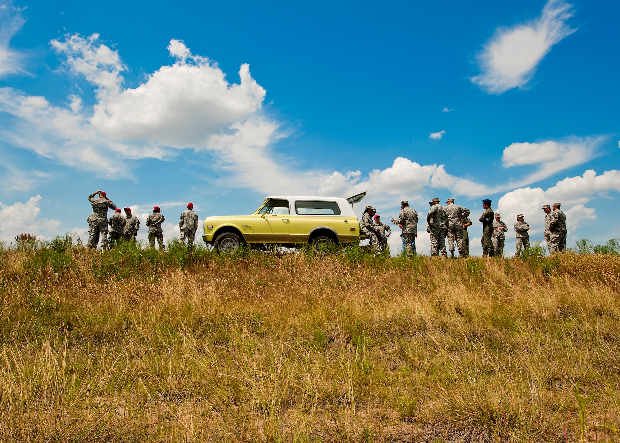Servicemembers from the Air Force, Army and National Guard gather in front of a Fort Hood drop zone prior to a Joint Precision Airdrop System exercise June 6, 2012, at Fort Hood, Texas. JPADS is an airdrop system that uses Global Positioning Satellite, steerable parachutes and an onboard computer to steer loads to a designated point of impact on a drop zone - similar to joint direct attack munitions. (U.S. Air Force photo by Airman 1st Class Damon Kasberg /Released)