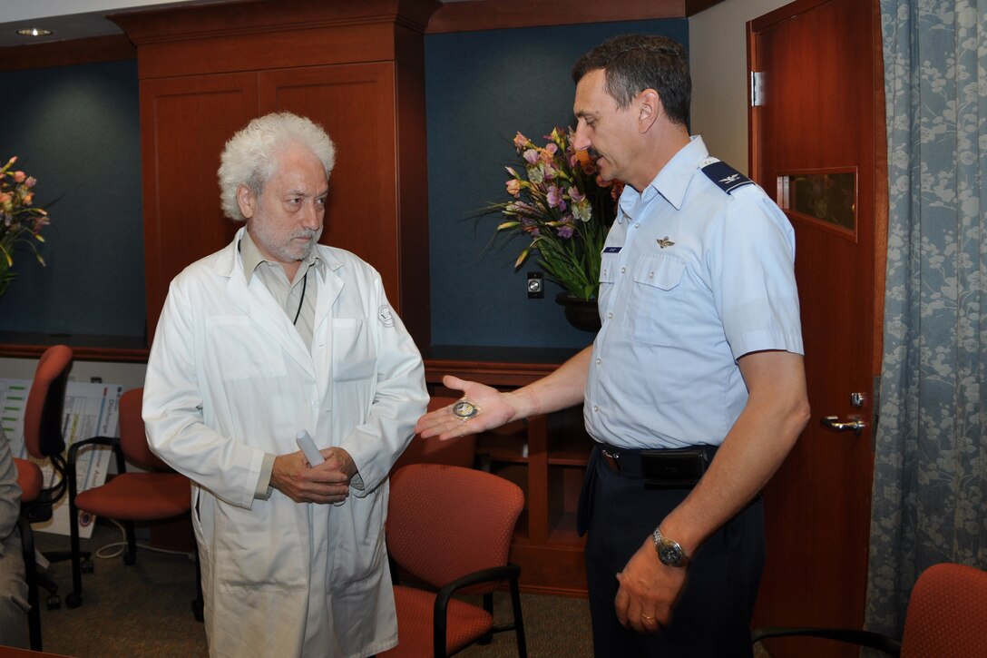 LOUIS STOKES CLEVELAND VA MEDICAL CENTER, Ohio – Col. Reinhard Schmidt, 910th Airlift Wing commander, presents Dr. Murray Altose, Cleveland VA Medical Center chief of staff, with a coin of excellence to thank him for the work he’s done for veterans at the Louis Stokes Cleveland Medical Center June 4, 2012. The Cleveland VA is a multi-specialty outpatient clinic and vet center that includes specialized programs such as blind rehabilitation, polytrauma care, invasive cardiology, post-traumatic stress disorders, comprehensive cancer center and several other areas of expertise. (U.S. Air Force photo by Staff Sgt. Megan Tomkins)