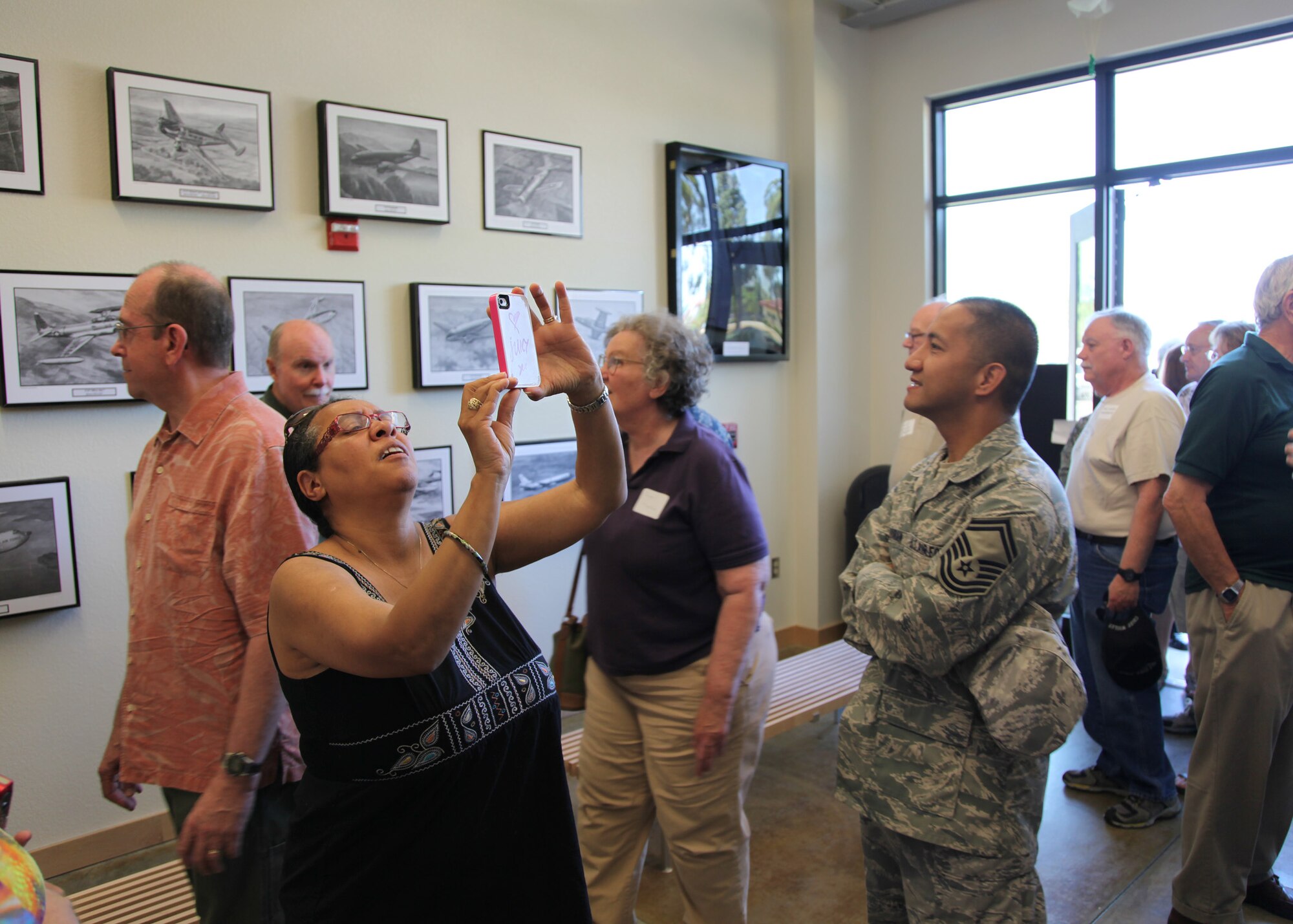 TRAVIS AIR FORCE BASE, Calif. -- Current and past members of the 349th Air Mobility Wing admire displays in the Heritage Hall in the Wing Headquarters during Alumni Day, June 2, 2012 at Travis Air Force Base, Calif.  The day's events also included a BBQ lunch sponsored by the 349th Chiefs Group, the 349th Officer's Spouses Club and Mr. Stanley Davis; and a static display tour of a C-17 Globemaster III.  The day's festivities cumulated with a banquet featuring remarks by Brig. Gen. Dale R. Baumler, former 349 AMW and 14th Air Force commander; and by Brig. Gen. John C. Flournoy, Jr., current 349 AMW commander; and music by the Band of the Golden West. (U.S. Air Force photo / Lt. Col. Robert Couse-Baker)
