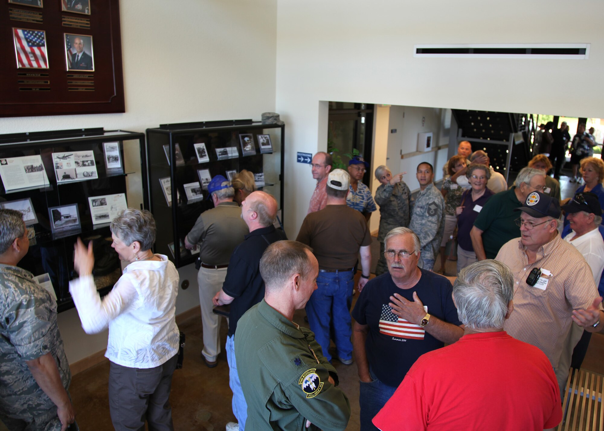 TRAVIS AIR FORCE BASE, Calif. --Current and past members of the 349th Air Mobility Wing admire displays in the Heritage Hall in the Wing Headquarters during Alumni Day, June 2, 2012 at Travis Air Force Base, Calif.  The day's events also included a BBQ lunch sponsored by the 349th Chiefs Group, the 349th Officer's Spouses Club and Mr. Stanley Davis; and a static display tour of a C-17 Globemaster III.  The day's festivities cumulated with a banquet featuring remarks by Brig. Gen. Dale R. Baumler, former 349 AMW and 14th Air Force commander; and by Brig. Gen. John C. Flournoy, Jr., current 349 AMW commander; and music by the Band of the Golden West. (U.S. Air Force photo / Lt. Col. Robert Couse-Baker)
