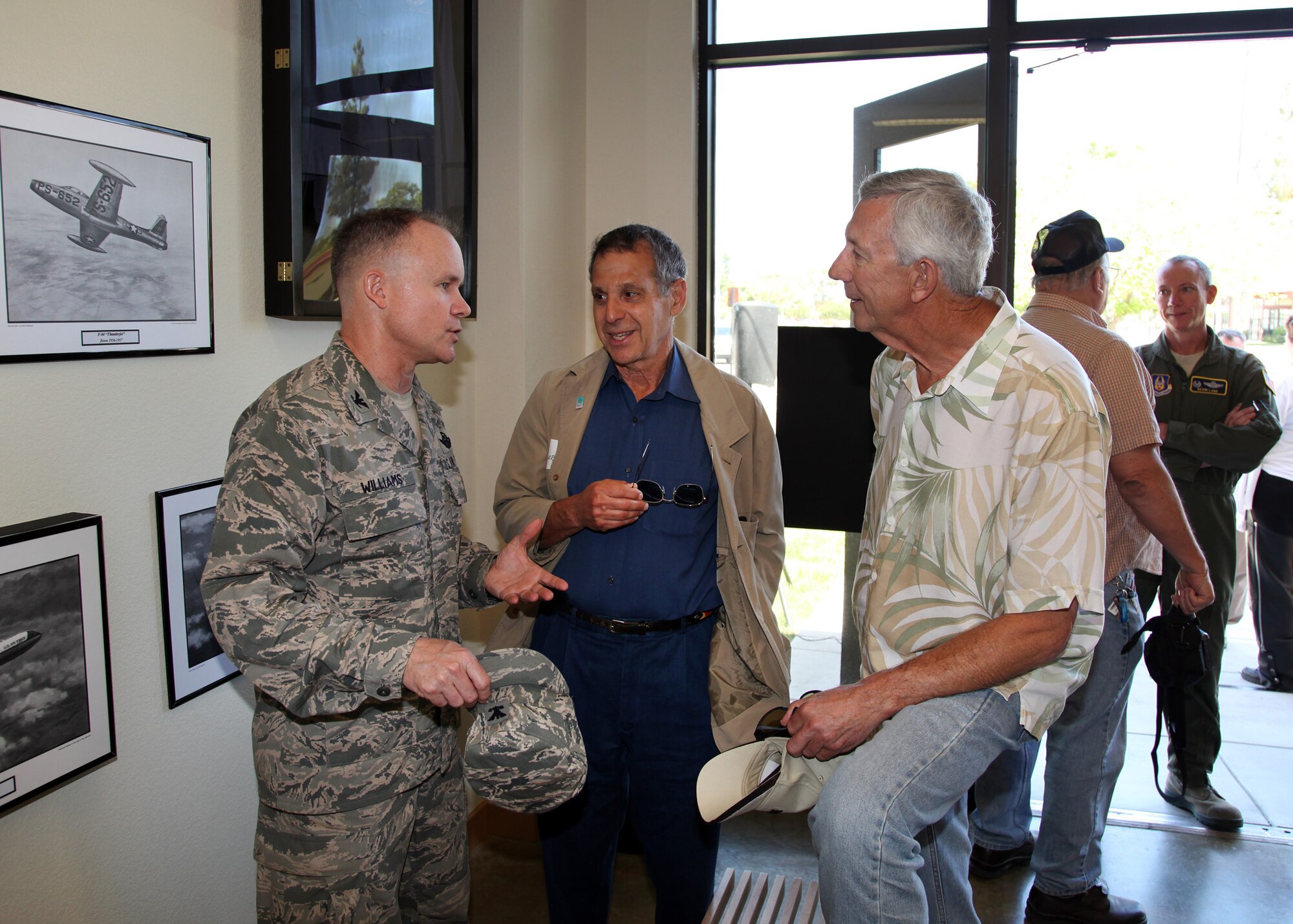 TRAVIS AIR FORCE BASE, Calif. -- Col. John Williams, 349th Air Mobility Wing Vice Commander, talks with past members and admire displays in the Heritage Hall in the Wing Headquarters during Alumni Day, June 2, 2012 at Travis Air Force Base, Calif.  The day's events also included a BBQ lunch sponsored by the 349th Chiefs Group, the 349th Officer's Spouses Club and Mr. Stanley Davis; and a static display tour of a C-17 Globemaster III.  The day's festivities cumulated with a banquet featuring remarks by Brig. Gen. Dale R. Baumler, former 349 AMW and 14th Air Force commander; and by Brig. Gen. John C. Flournoy, Jr., current 349 AMW commander; and music by the Band of the Golden West. (U.S. Air Force photo / Lt. Col. Robert Couse-Baker)