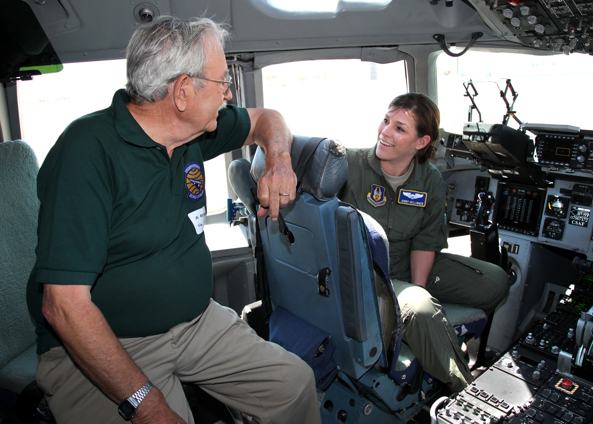 TRAVIS AIR FORCE BASE, Calif. -- During the 349th Air Mobility Wing Alumni Day, Lt. Col. Al Bekebrede (Retired), former commander of the 301st airlift squadron, speaks with Capt. Jenny Hellinger, a pilot currently serving with the 301st, on the flight deck of C-17 Globemaster III at Travis Air Force Base, Calif., June 2, 2012.  When Bekebrede was commander in 1972, the squadron flew the C-141 Starlifter. (U.S. Air Force photo / Lt. Col. Robert Couse-Baker)