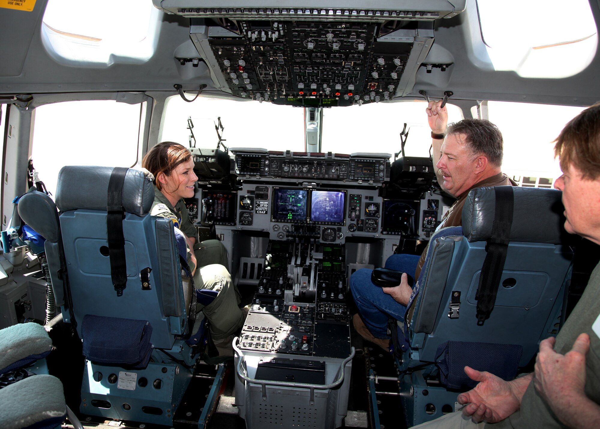 Capt. Jenny Hellinger, a pilot with the 301st Airlift Squadron,speaks former members of the unit on the flight deck of C-17 Globemaster III during the 349th Air Mobility Wing Alumni Dayat Travis Air Force Base, Calif., June 2, 2012.  (U.S. Air Force photo / Lt. Col. Robert Couse-Baker)