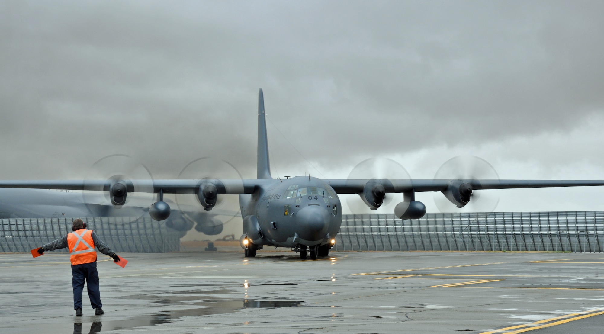 Randy Berum, transient alert aircraft servicer, marshals an Australian air force C-130 Hercules to the runway. (U.S. Air Force photo/Airman 1st Class Madelyn Ottem)